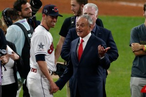 Rob Manfred making a "hey it's just doubling the size of the postseason" face next to Shane Bieber.