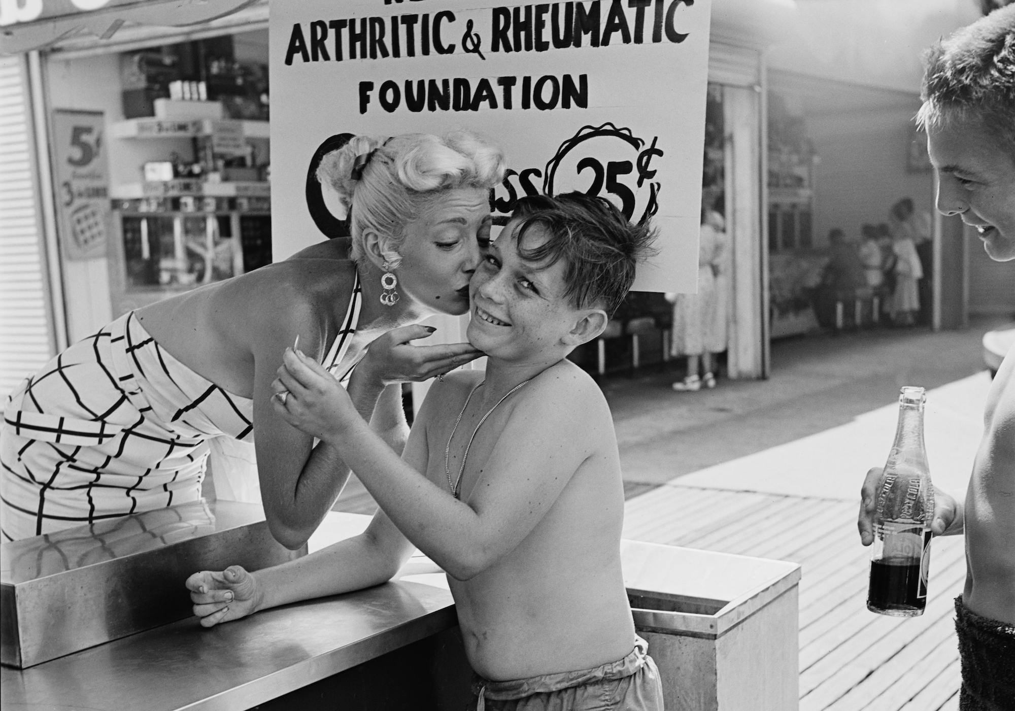 A kissing booth in aid of the New York Arthritic and Rheumatic Foundation, charging 25 cents a kiss, USA, 1953. (Photo by Carsten/Graphic House/Archive Photos/Getty Images)