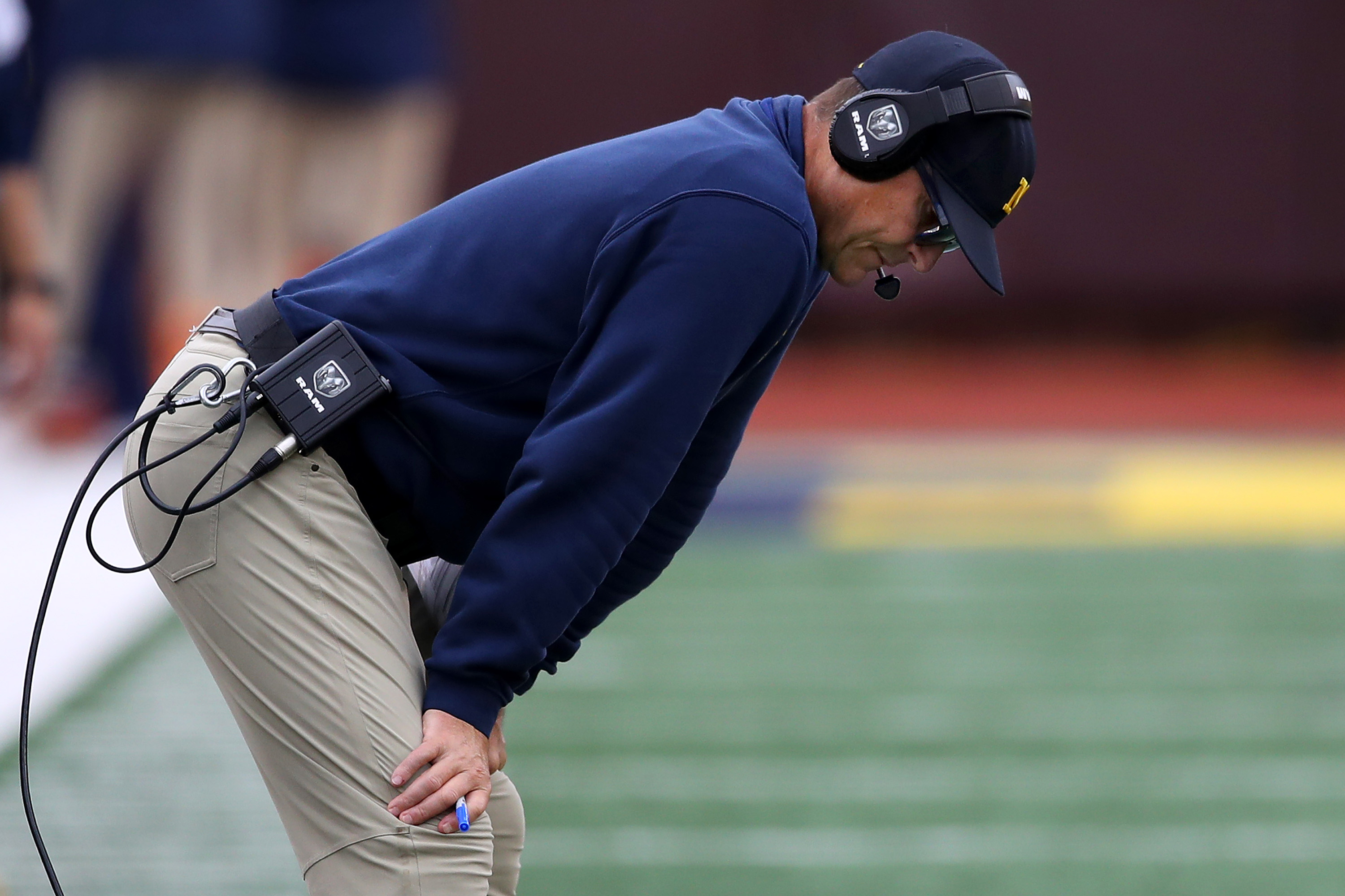 Head coach Jim Harbaugh of the Michigan Wolverines looks on in the first half while playing the Rutgers Scarlet Knights at Michigan Stadium