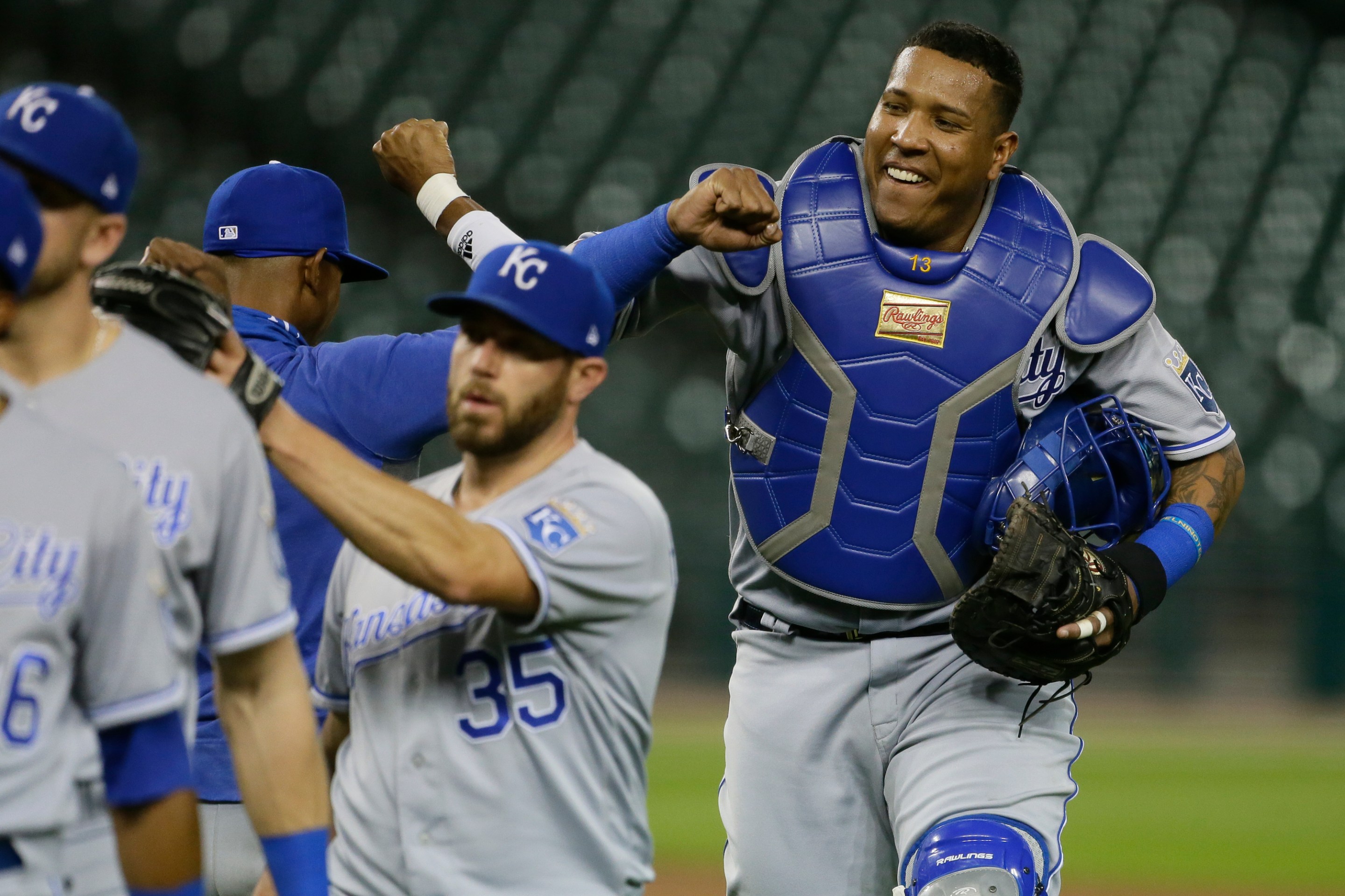 Salvador Perez congratulates his teammates, all of whom are somehow much smaller than him.