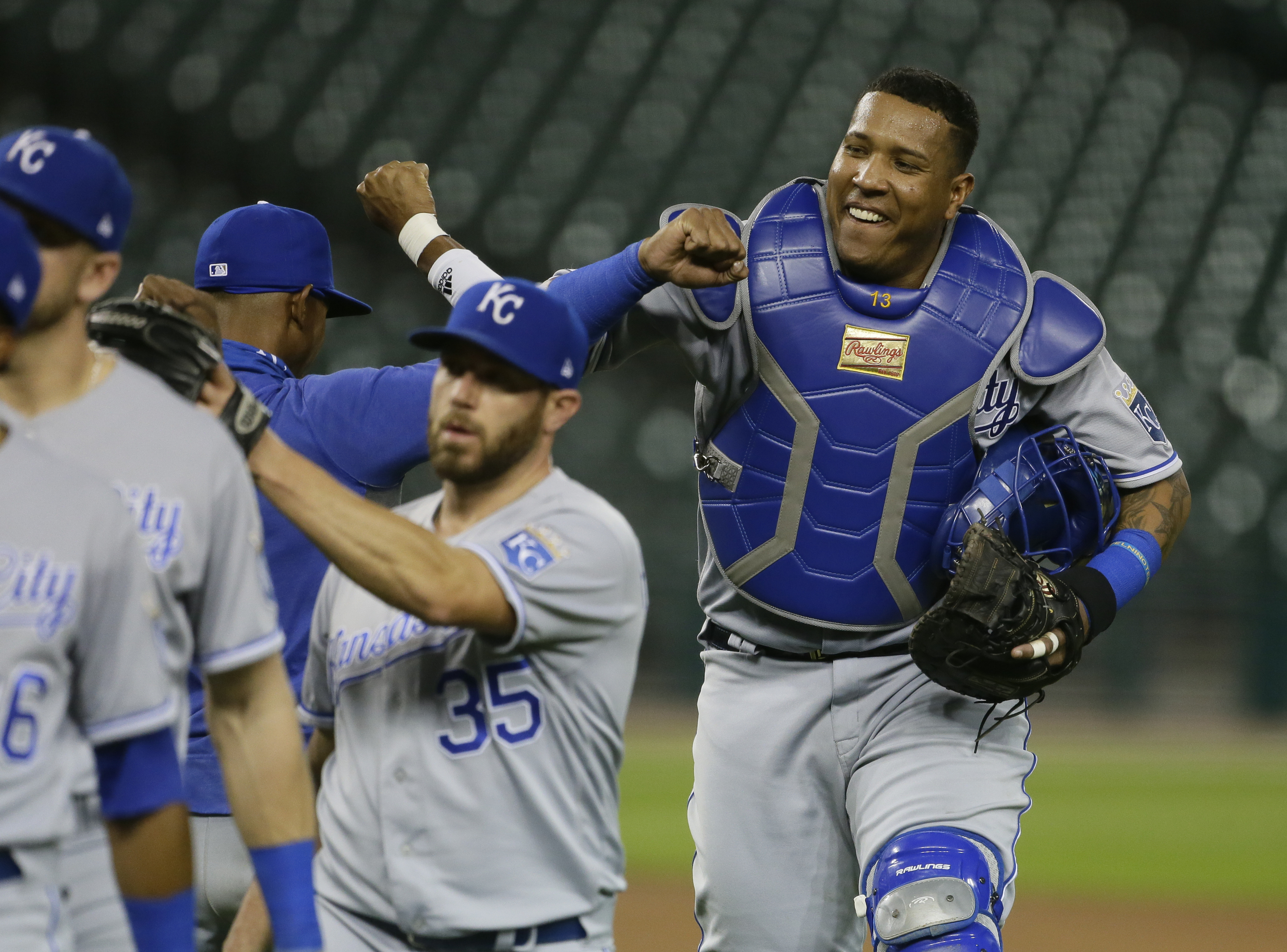 Salvador Perez congratulates his teammates, all of whom are somehow much smaller than him.