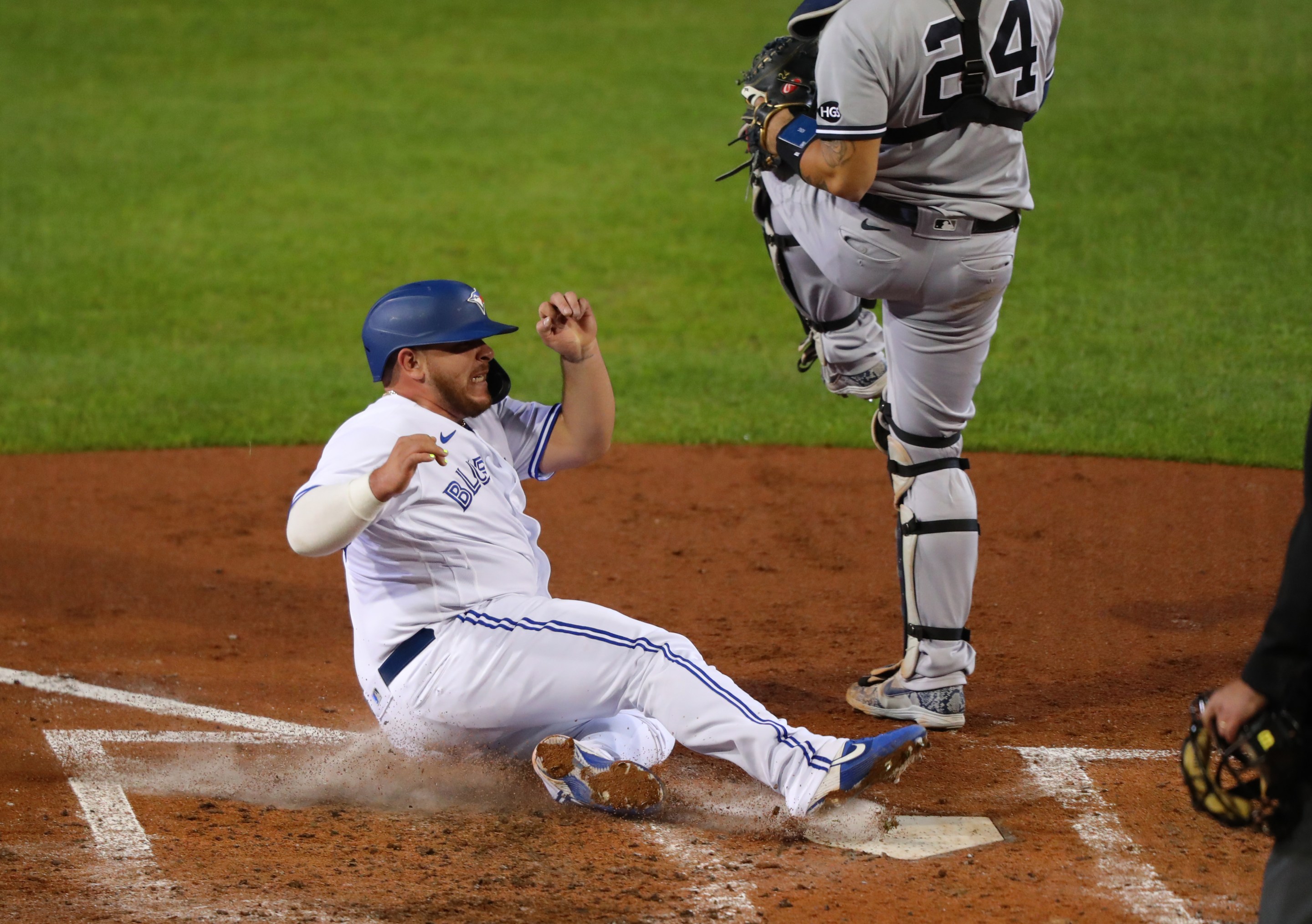 Alejandro Kirk #85 of the Toronto Blue Jays slides safely to home plate