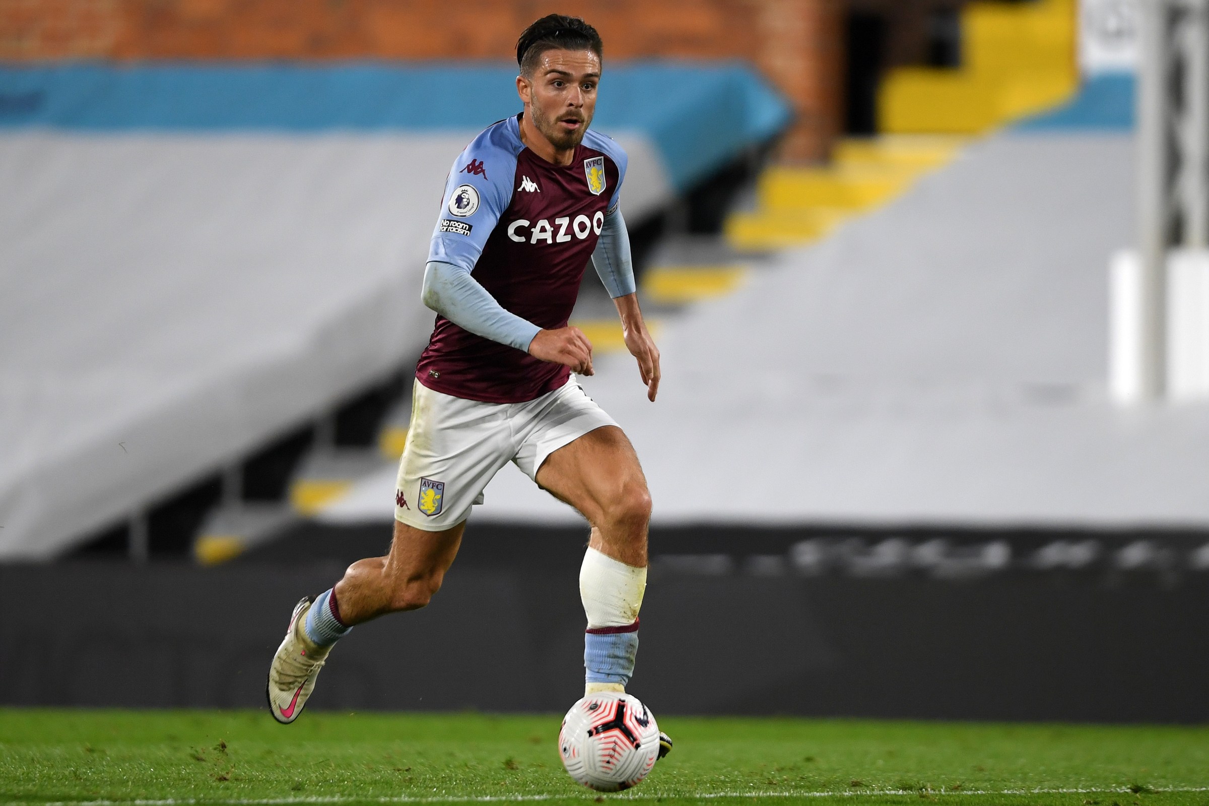 Aston Villa's English midfielder Jack Grealish runs with the ball during the English Premier League football match between Fulham and Aston Villa at Craven Cottage in London on September 28, 2020.