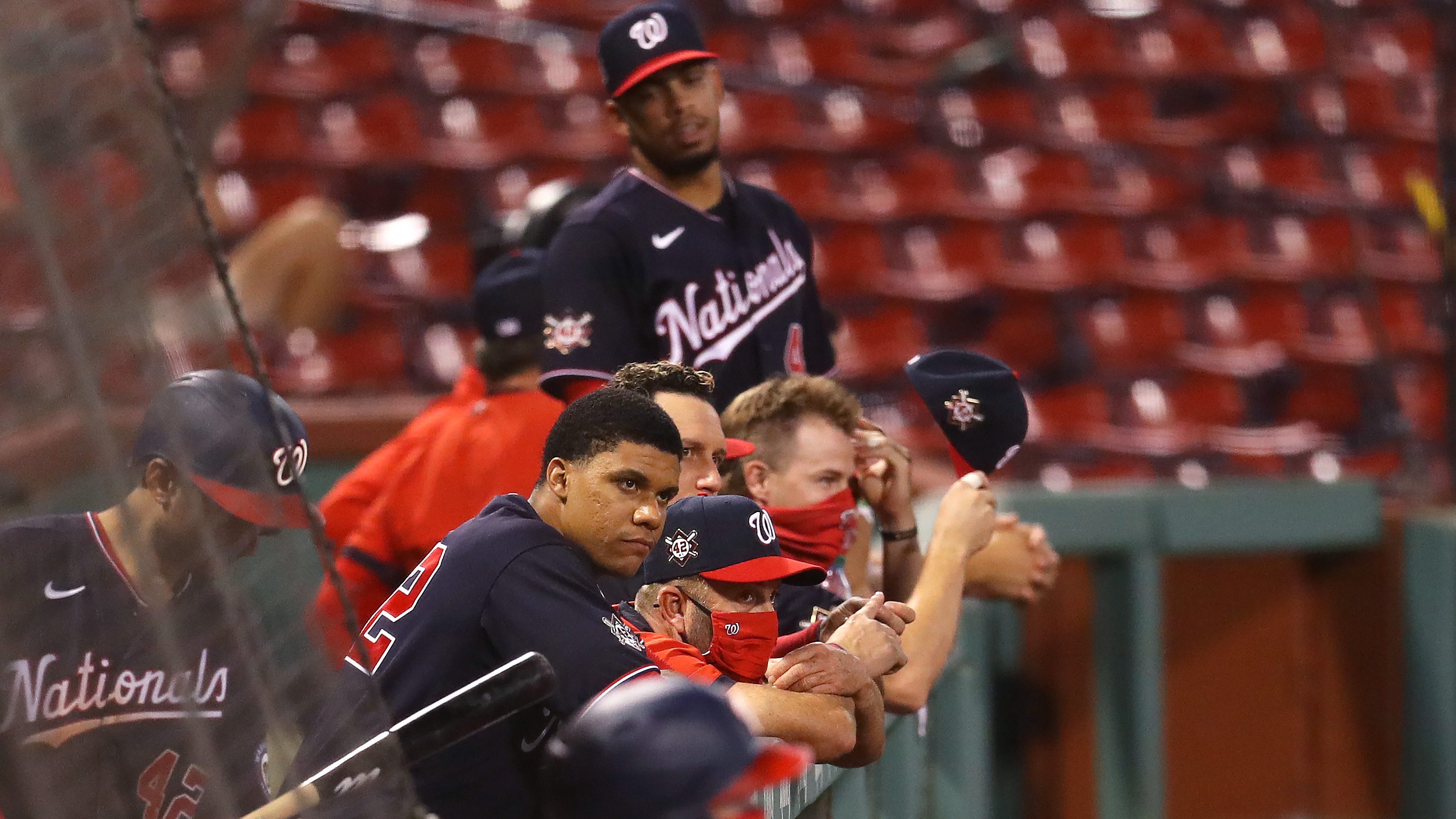 Washington Nationals players lean over the dugout railing during a game against the Boston Red Sox.