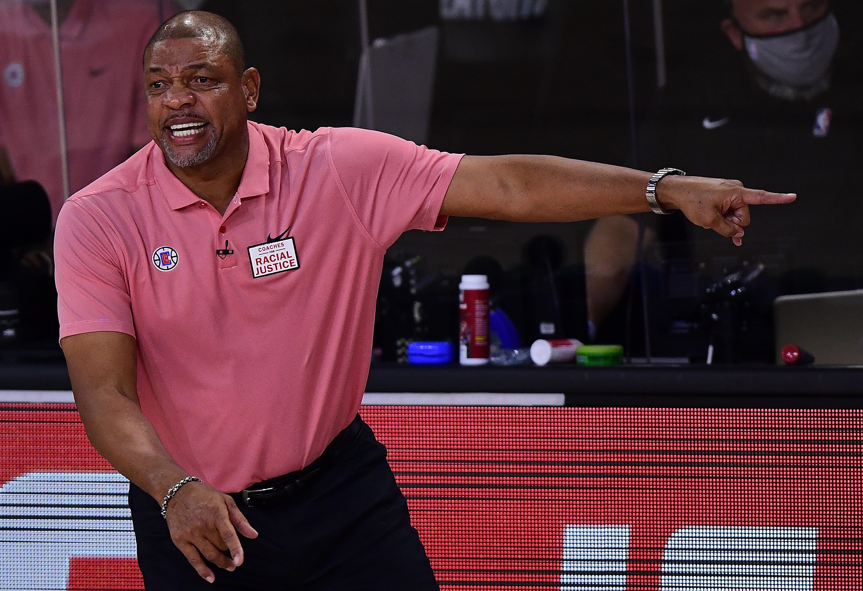 Doc Rivers looks amused on the sidelines of a Clippers playoff game.