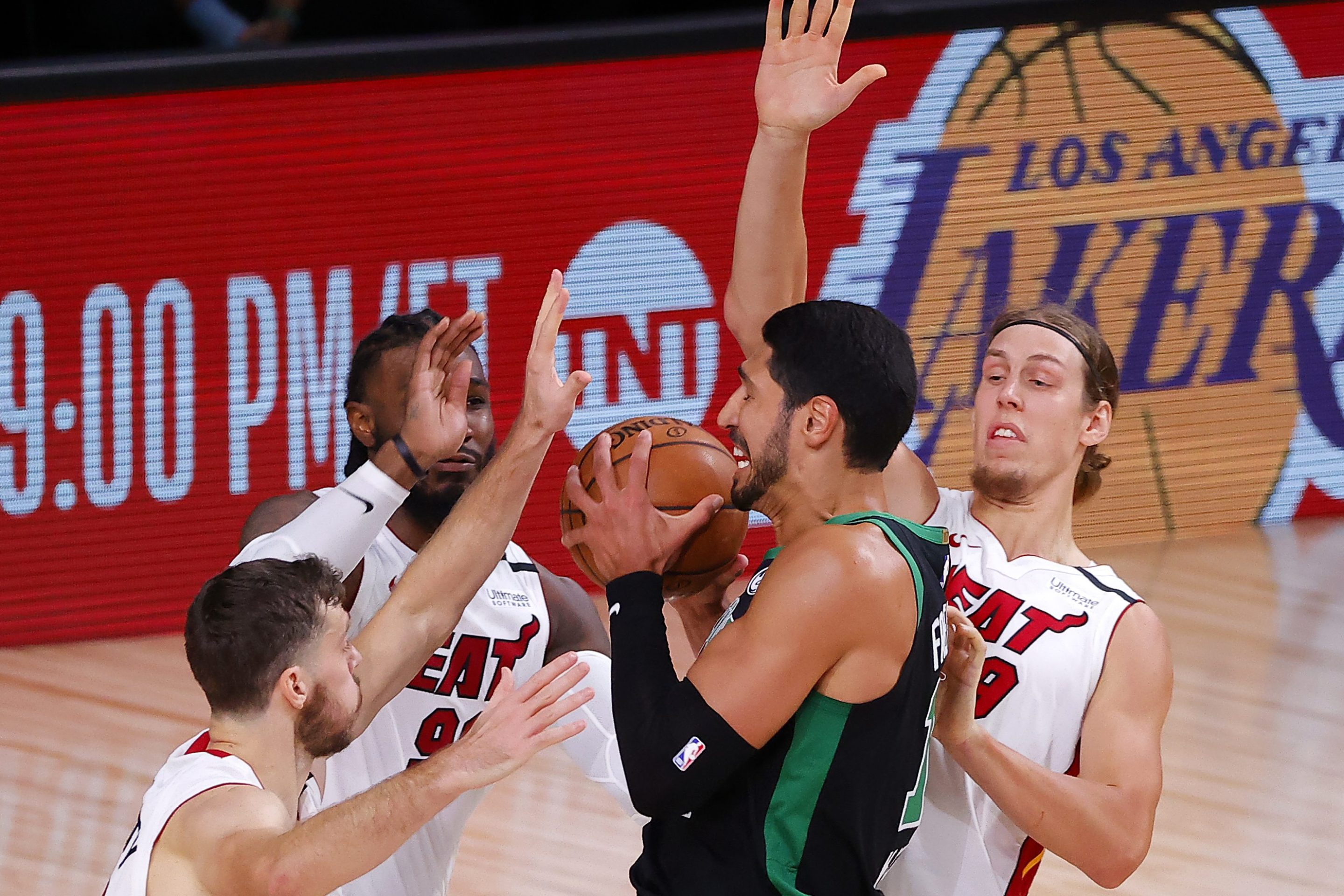 Enes Kanter is defended by three Miami Heat players