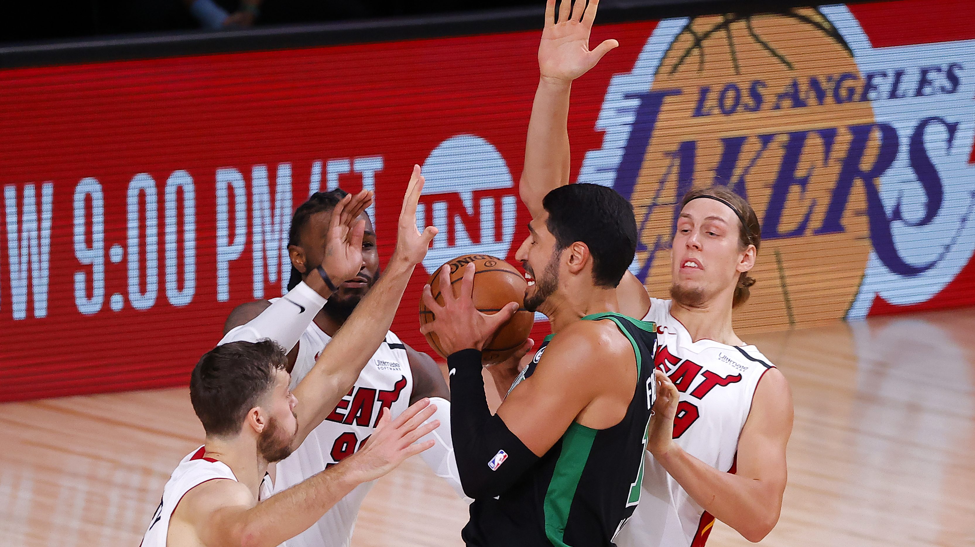 Enes Kanter is defended by three Miami Heat players