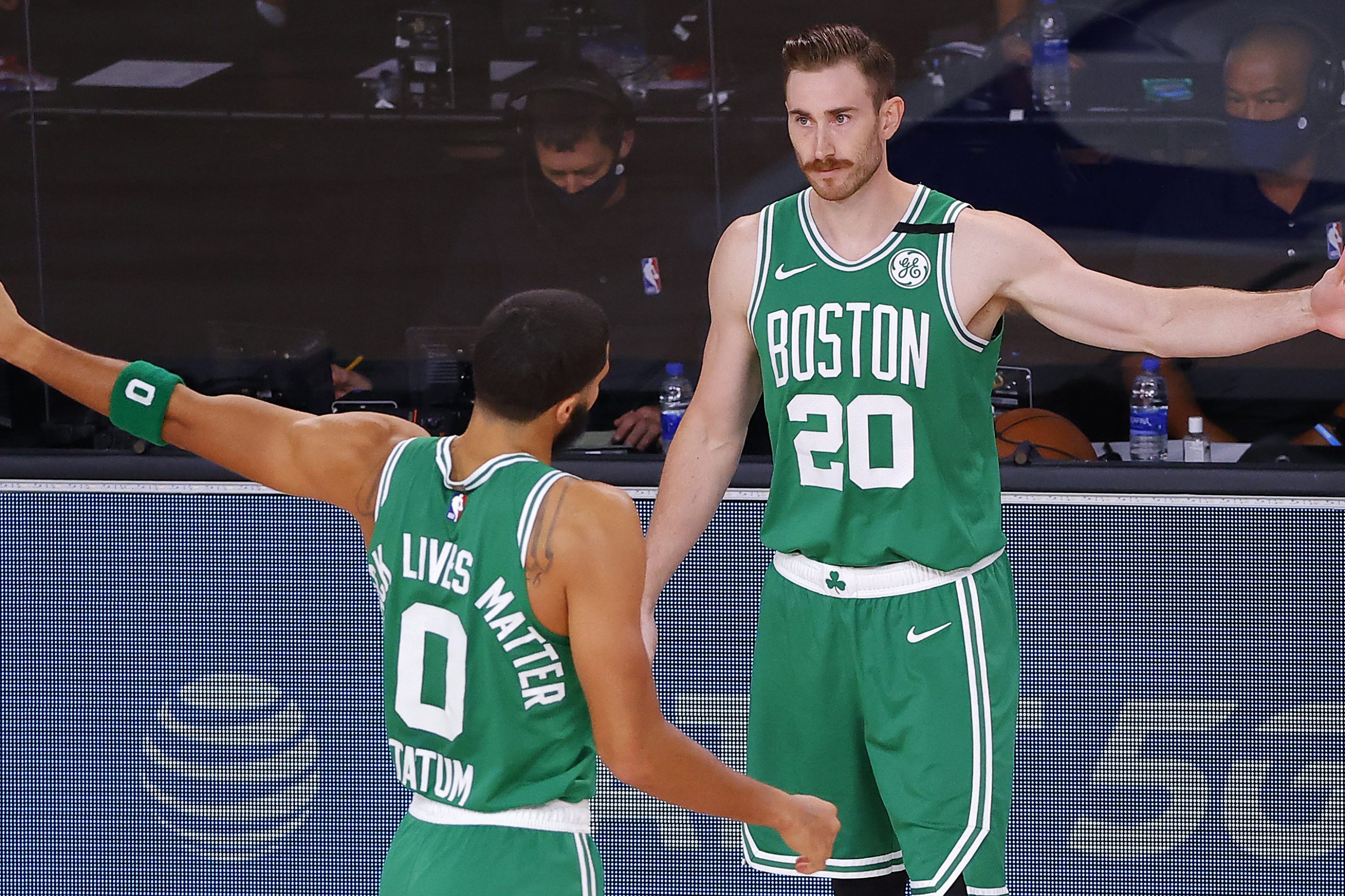 Gordon Hayward and Jayson Tatum greet each other on the sideline of a Celtics playoff game.