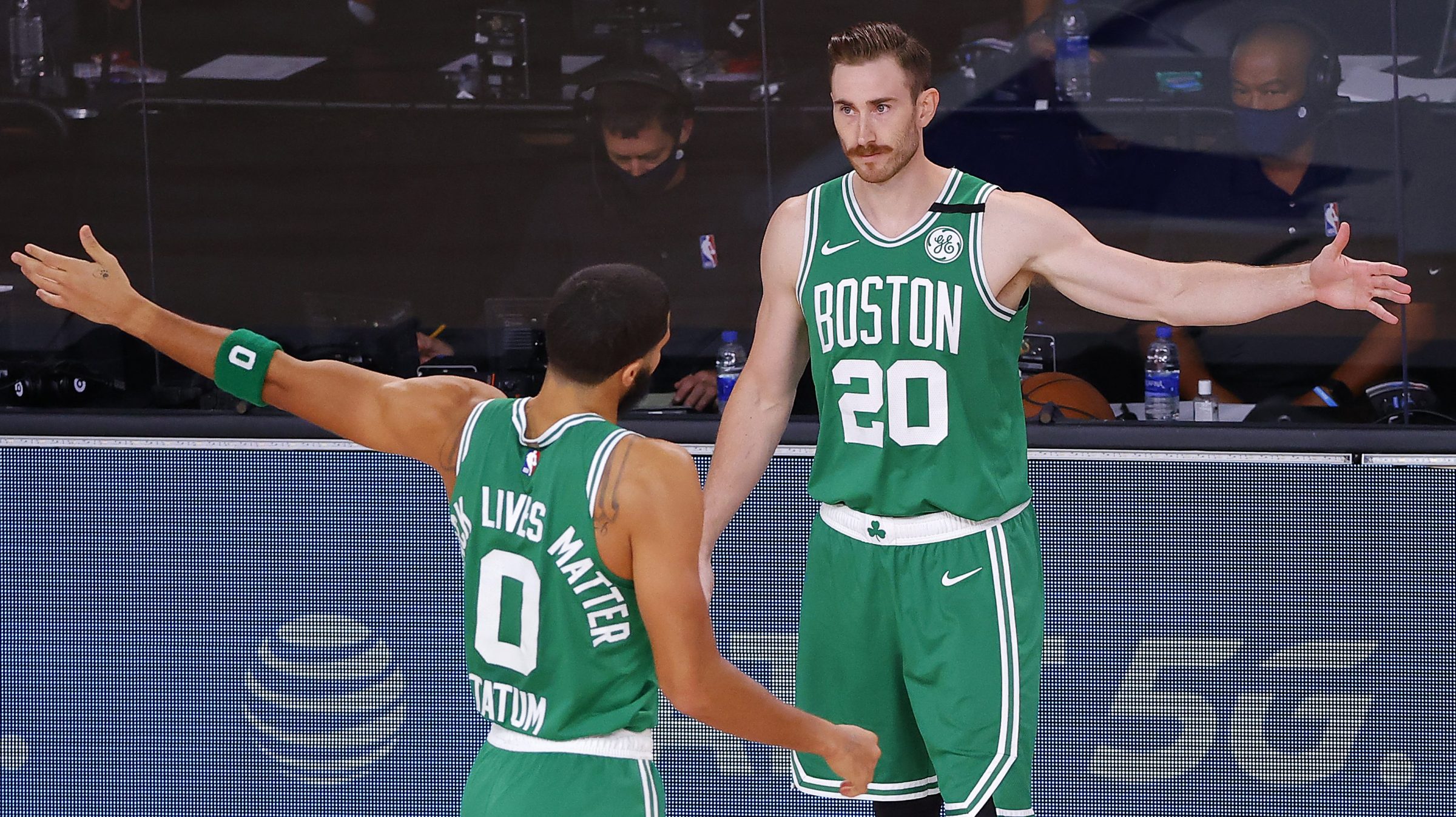 Gordon Hayward and Jayson Tatum greet each other on the sideline of a Celtics playoff game.