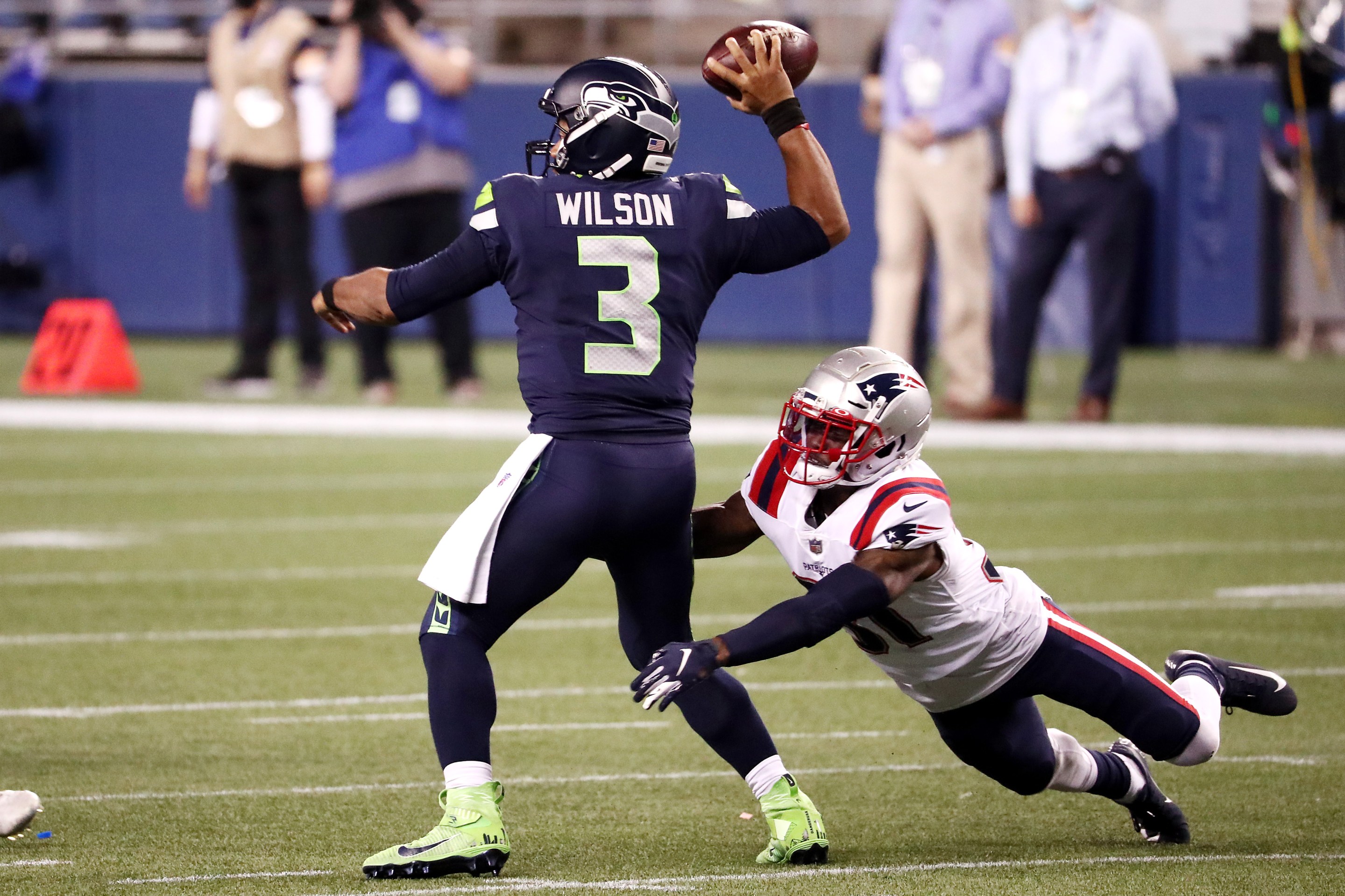 Jonathan Jones #31 of the New England Patriots attempts to tackle Russell Wilson #3 of the Seattle Seahawks