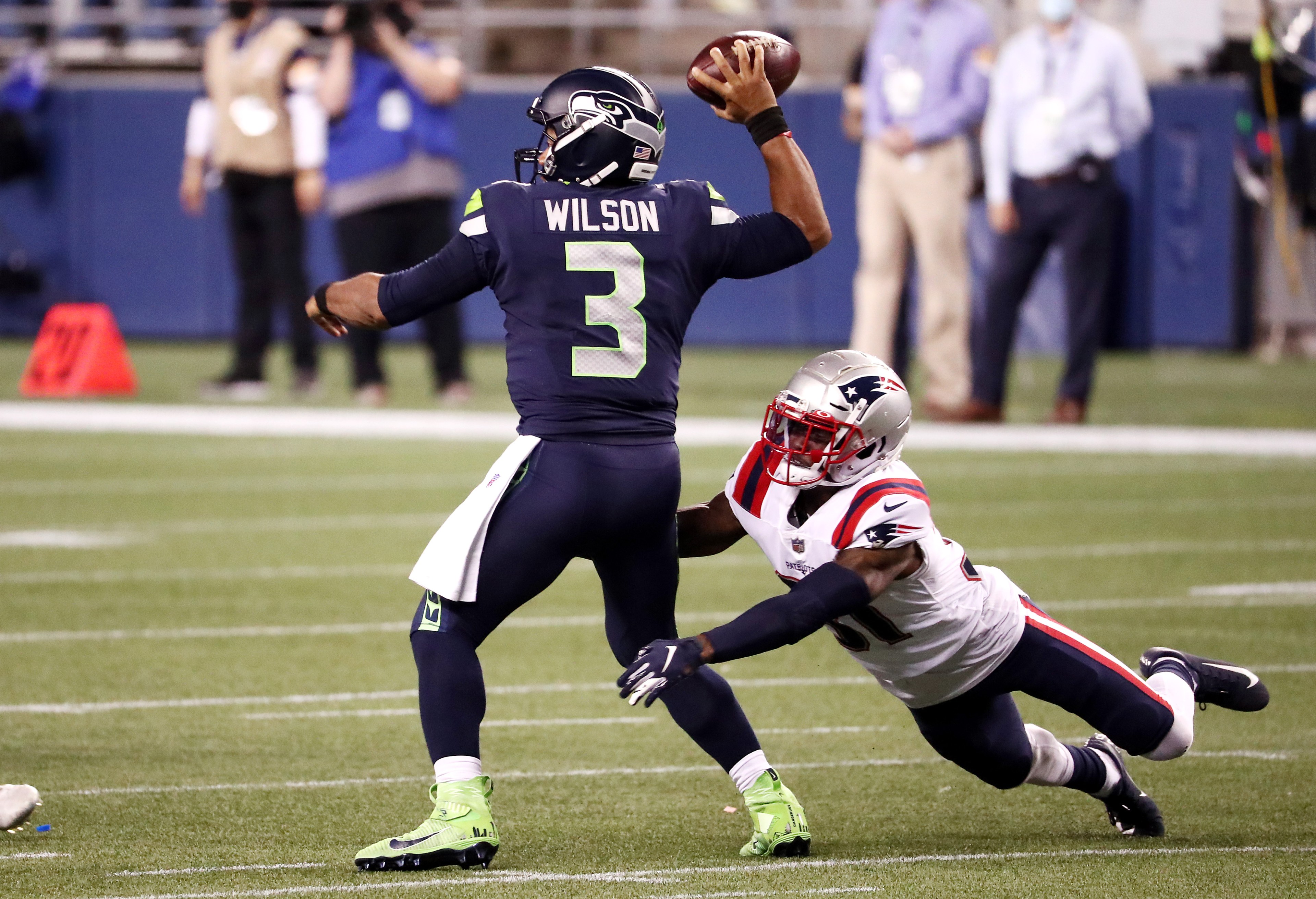 Jonathan Jones #31 of the New England Patriots attempts to tackle Russell Wilson #3 of the Seattle Seahawks