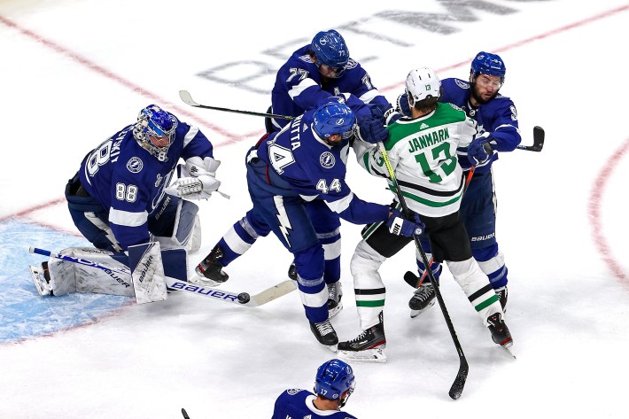 Mattias Janmark #13 of the Dallas Stars is checked by Victor Hedman #77 and Tyler Johnson #9 of the Tampa Bay Lightning