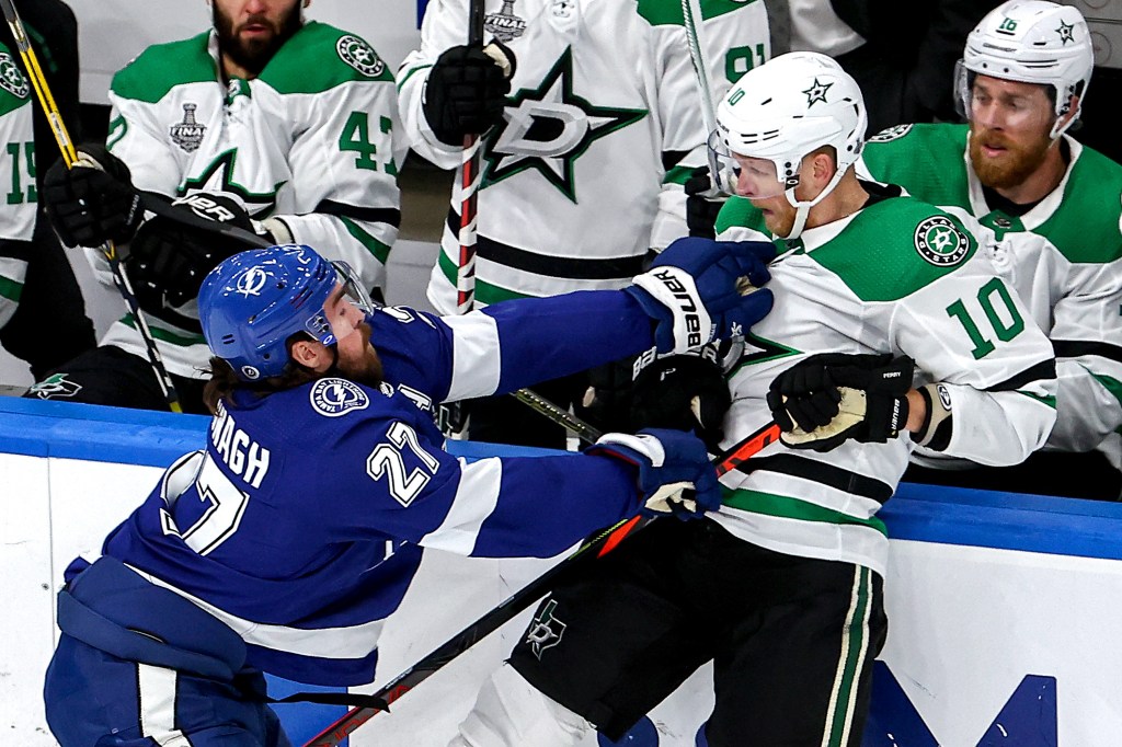 Corey Perry #10 of the Dallas Stars is checked by Ryan McDonagh #27 of the Tampa Bay Lightning