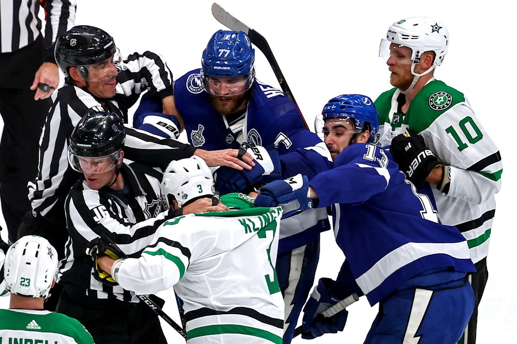 Victor Hedman #77 and Cedric Paquette #13 of the Tampa Bay Lightning scuffle with John Klingberg #3 of the Dallas Stars