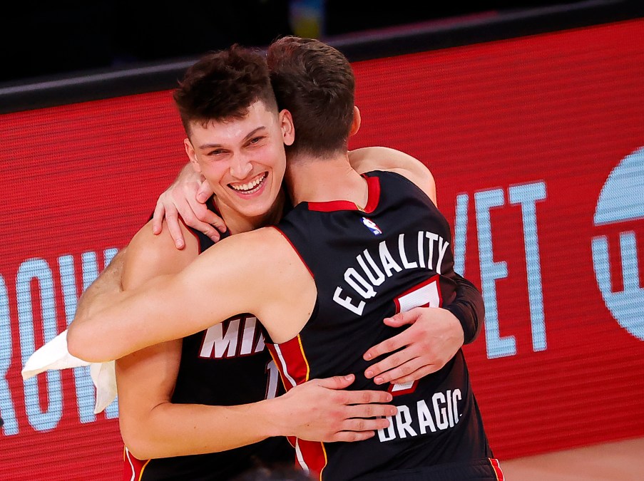 Tyler Herro #14 of the Miami Heat and Goran Dragic #7 of the Miami Heat react after their win over the Boston Celtics in Game Four of the Eastern Conference Finals.