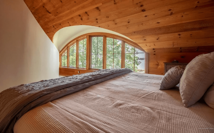 a curved window nestled inside a wooden wall