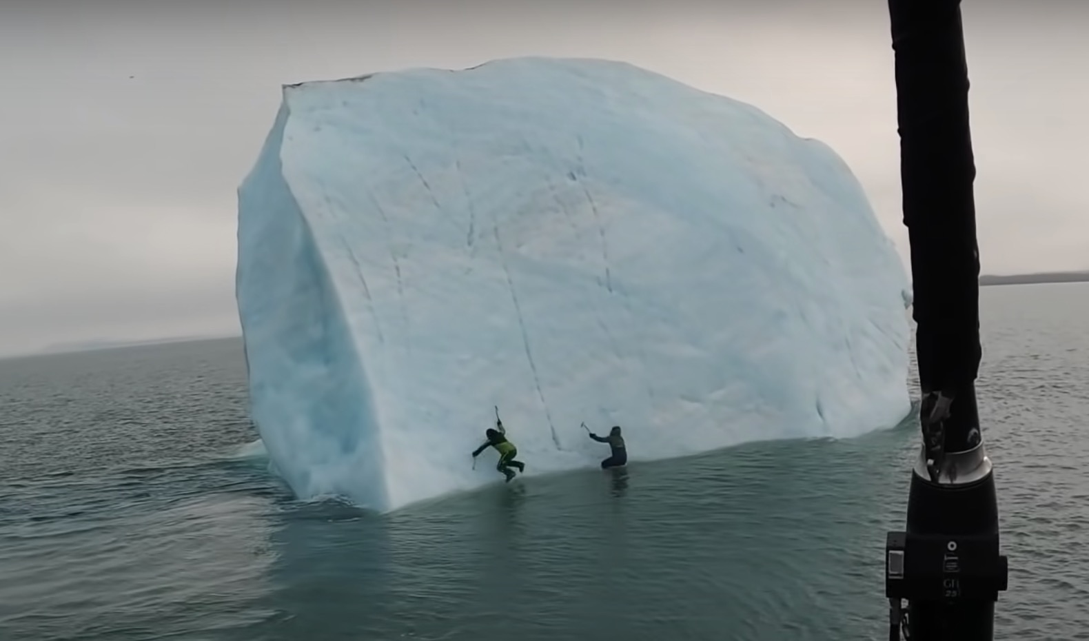 The two climbers scramble into the water.