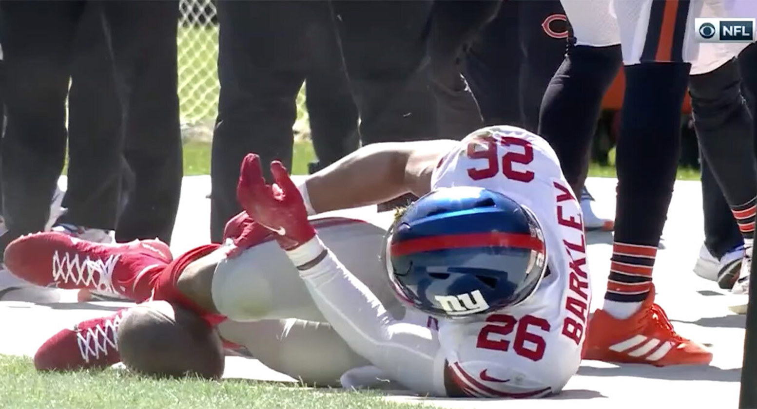 Saquon Barkley of the New York Giants holds his knee after being injured.