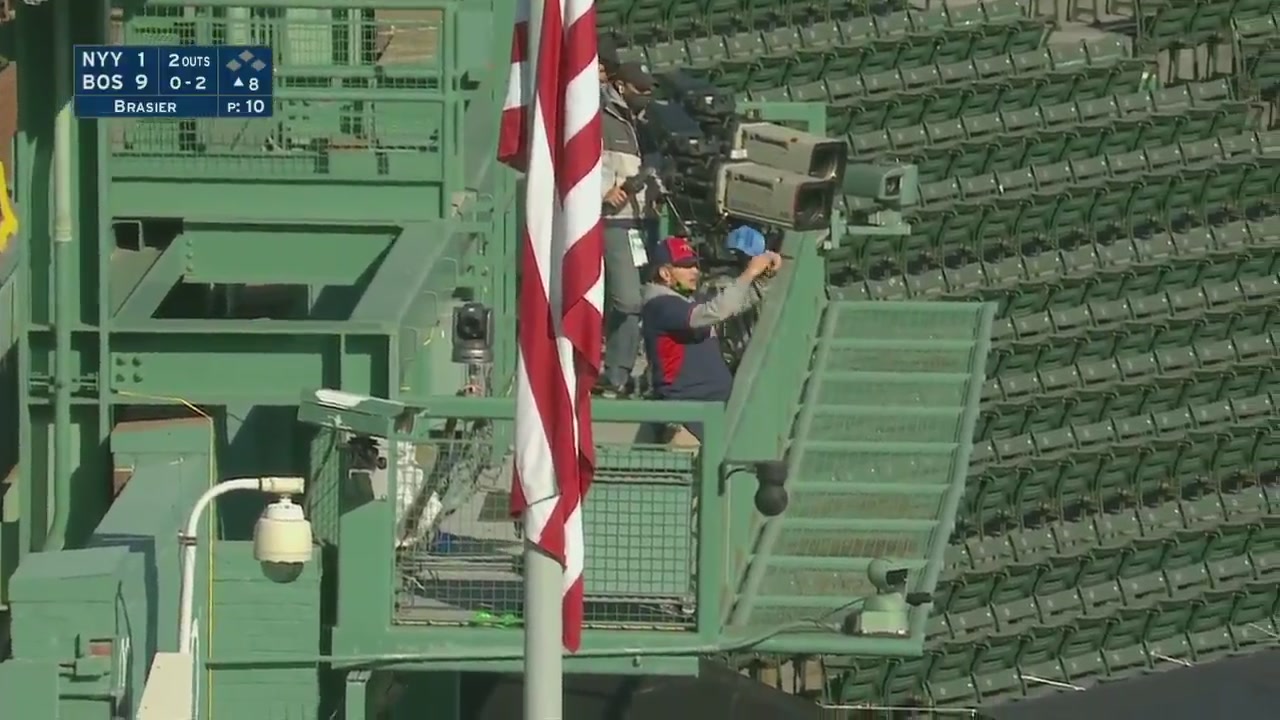 A fan stands in the stands and disrupts the game at Fenway Park