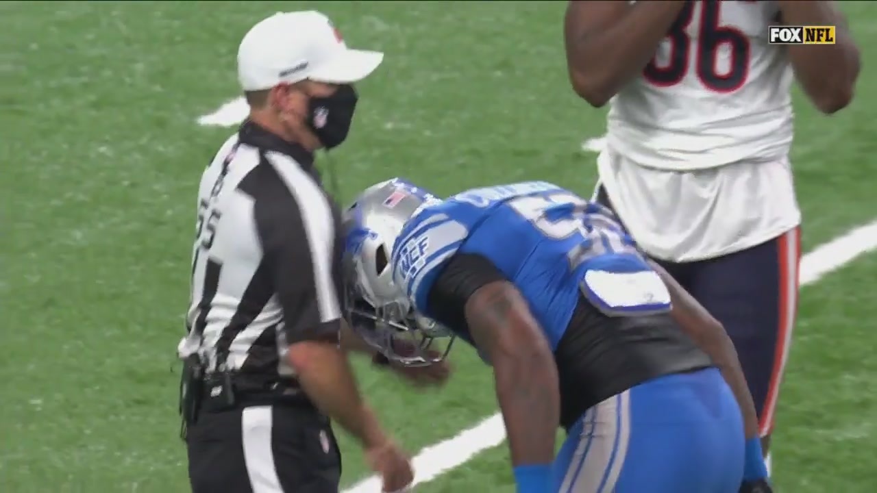 Lions defender Jamie Collins Sr. lowers his helmet and headbutts a referee in the shoulder
