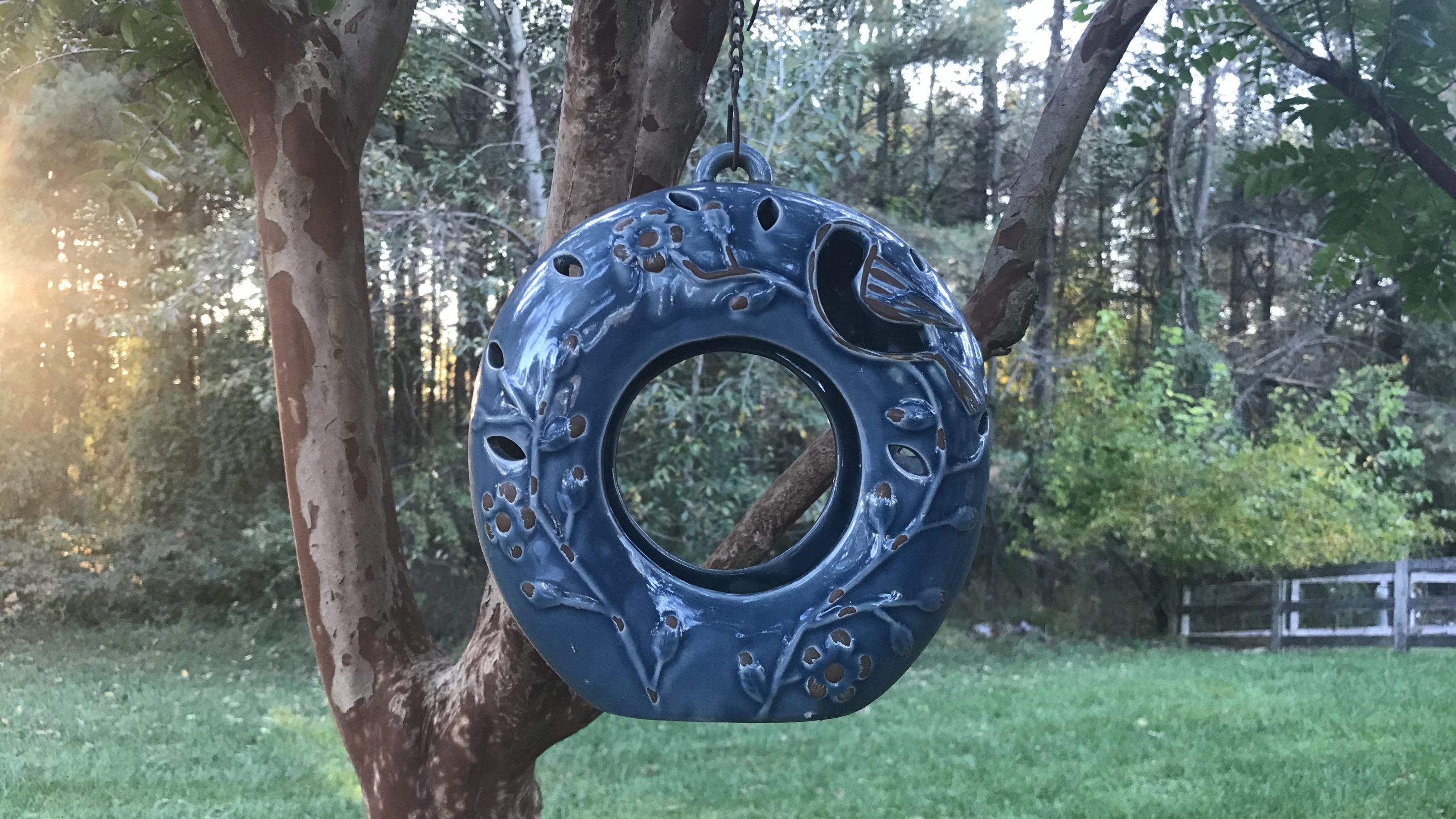 A blue ceramic bird-feeder.