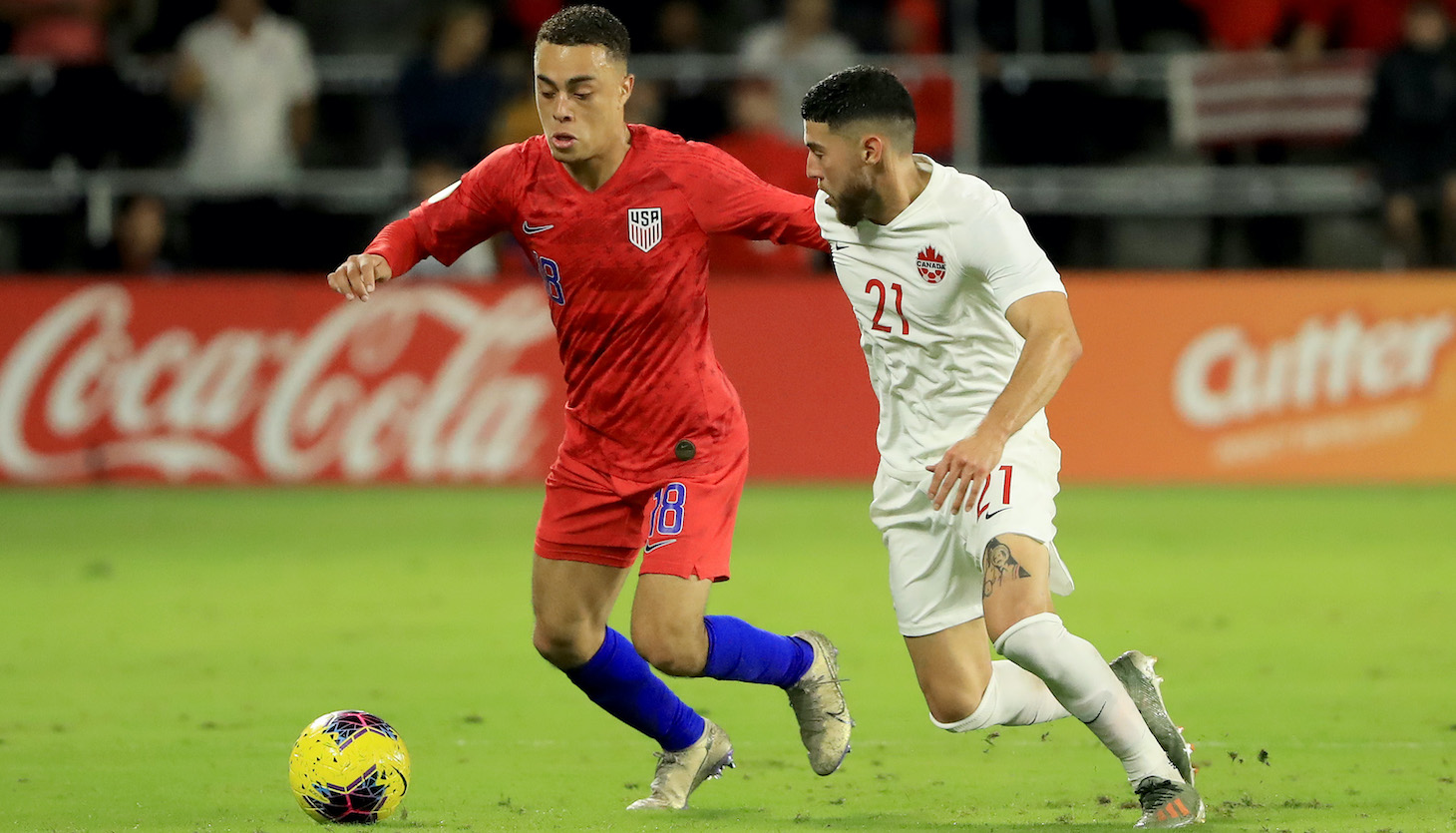Sergino Dest #18 of the United States drives against Jonathan Osorio #21 of Canada during the CONCACAF Nations League match at Exploria Stadium on November 15, 2019 in Orlando, Florida.