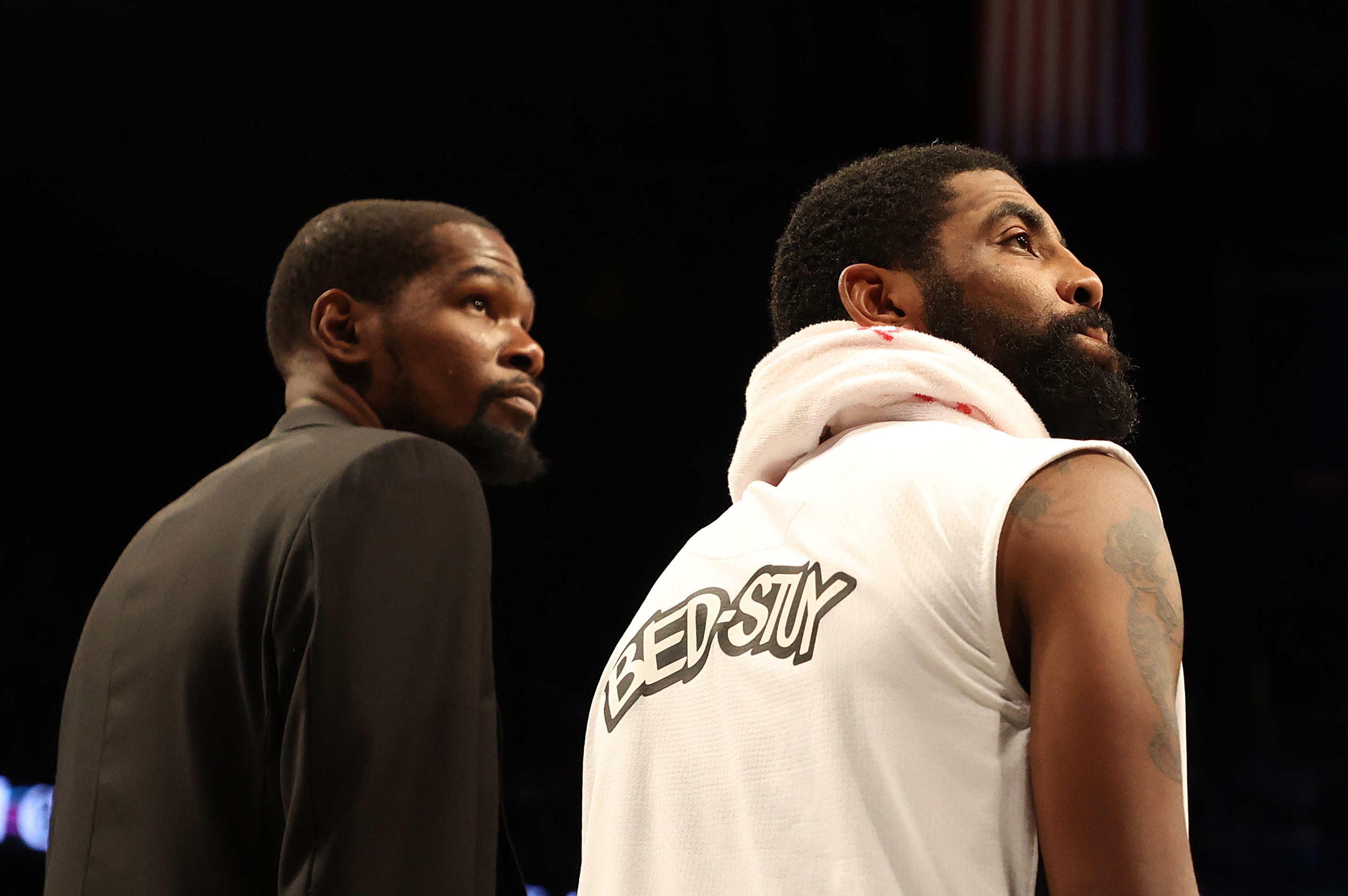 Kevin Durant and Kyrie Irving look in the same direction.
