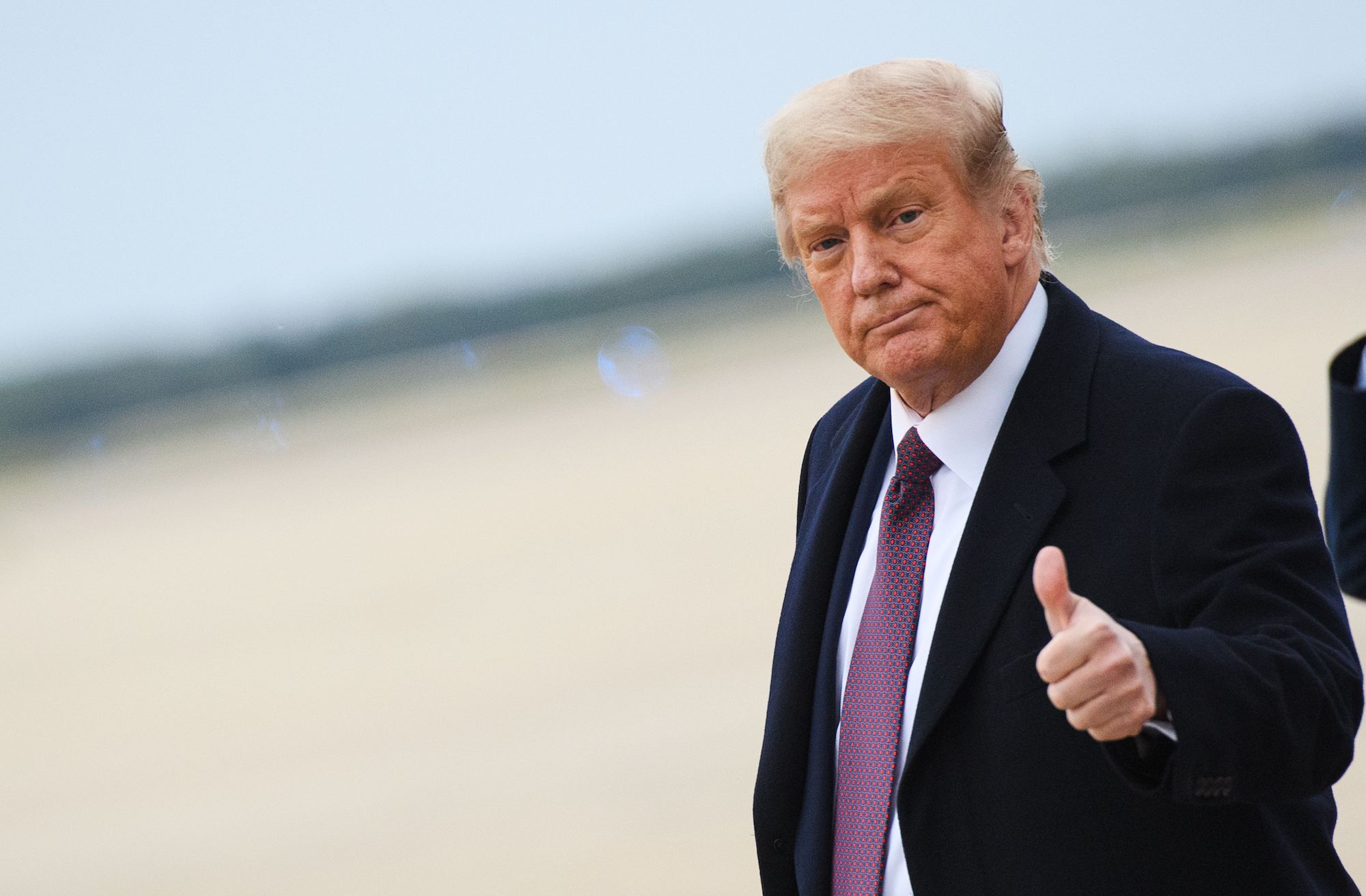 US President Donald Trump gives a thumbs up as he steps off Air Force One upon arrival at Andrews Air Force Base in Maryland on October 1, 2020. - The US president announced in the small hours of October 2, 2020, that he and First Lady Melania Trump would be going into quarantine after they were both found to have contracted the novel coronavirus. (Photo by MANDEL NGAN / AFP) (Photo by MANDEL NGAN/AFP via Getty Images)