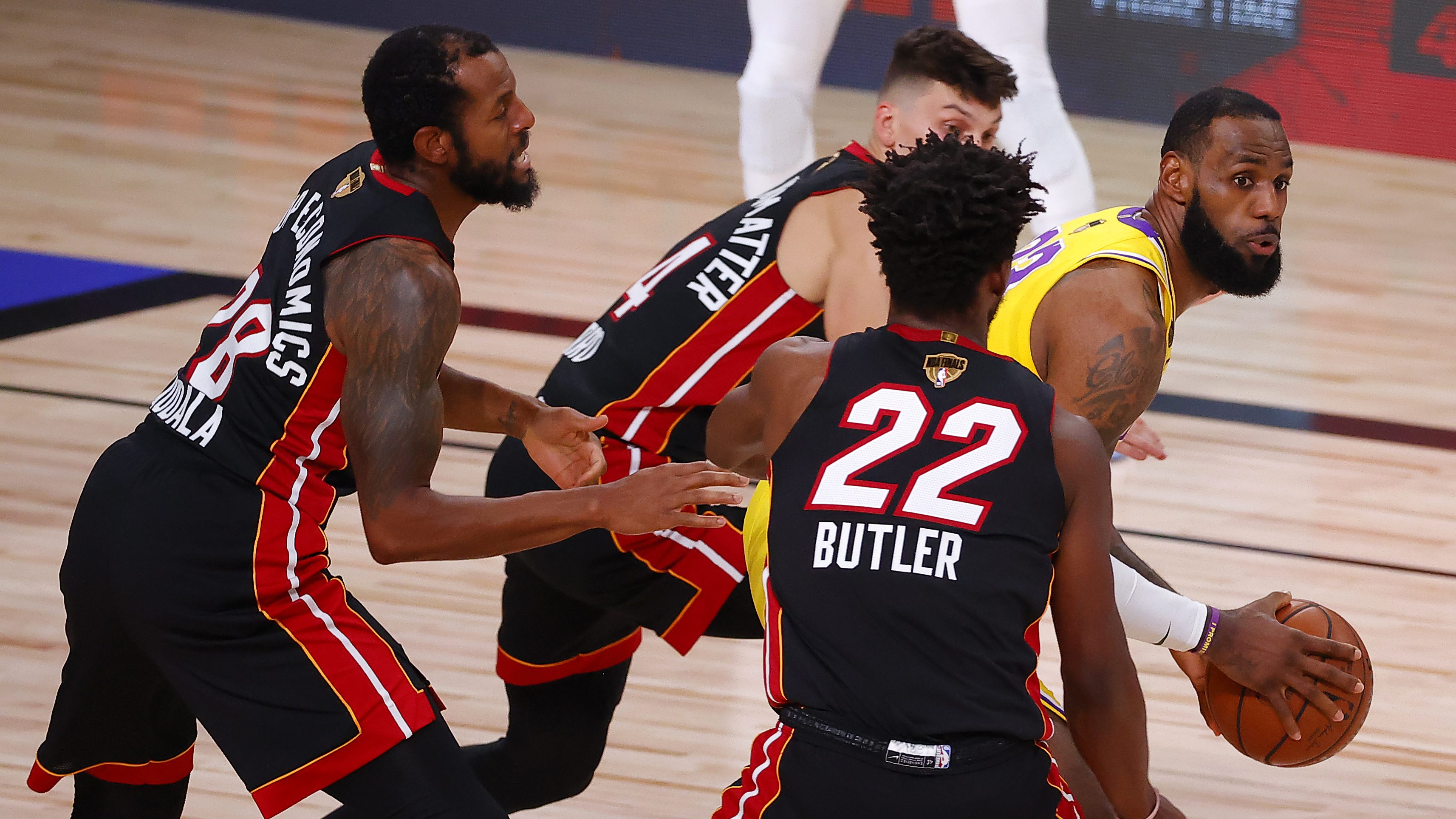 Several Heat players ineffectually harass LeBron James.