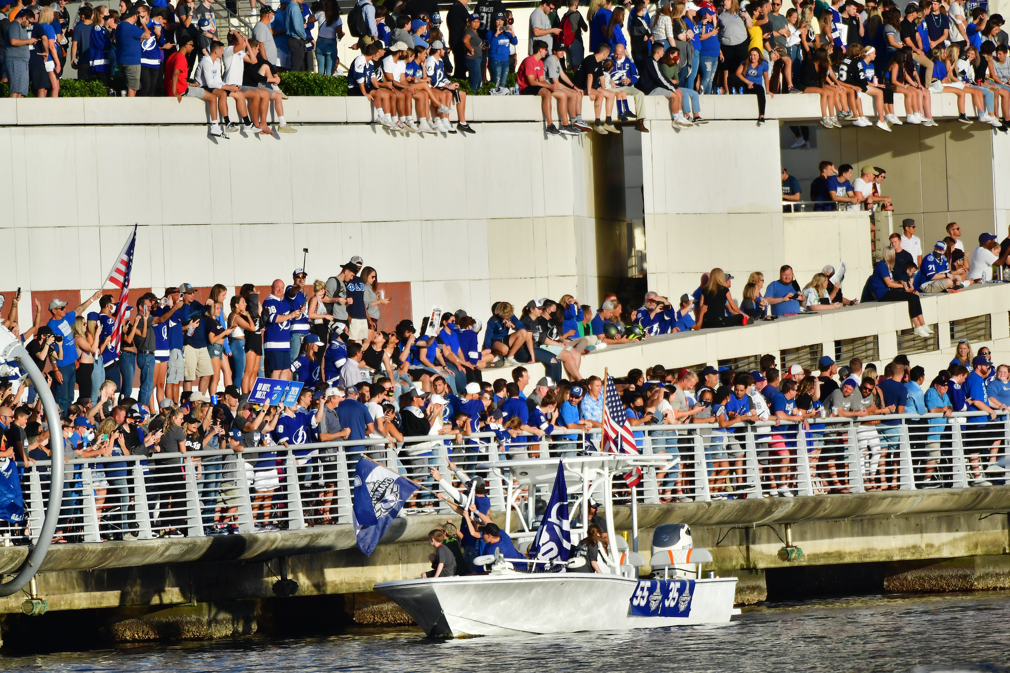 TAMPA, FLORIDA - SEPTEMBER 30: Braydon Coburn #55 and Curtis McElhinney #35 of the Tampa Bay Lightning wave to fans at the Tampa Bay Lightning Victory Rally &amp; Boat Parade on the Hillsborough river on September 30, 2020 in Tampa, Florida. (Photo by Julio Aguilar/Getty Images)