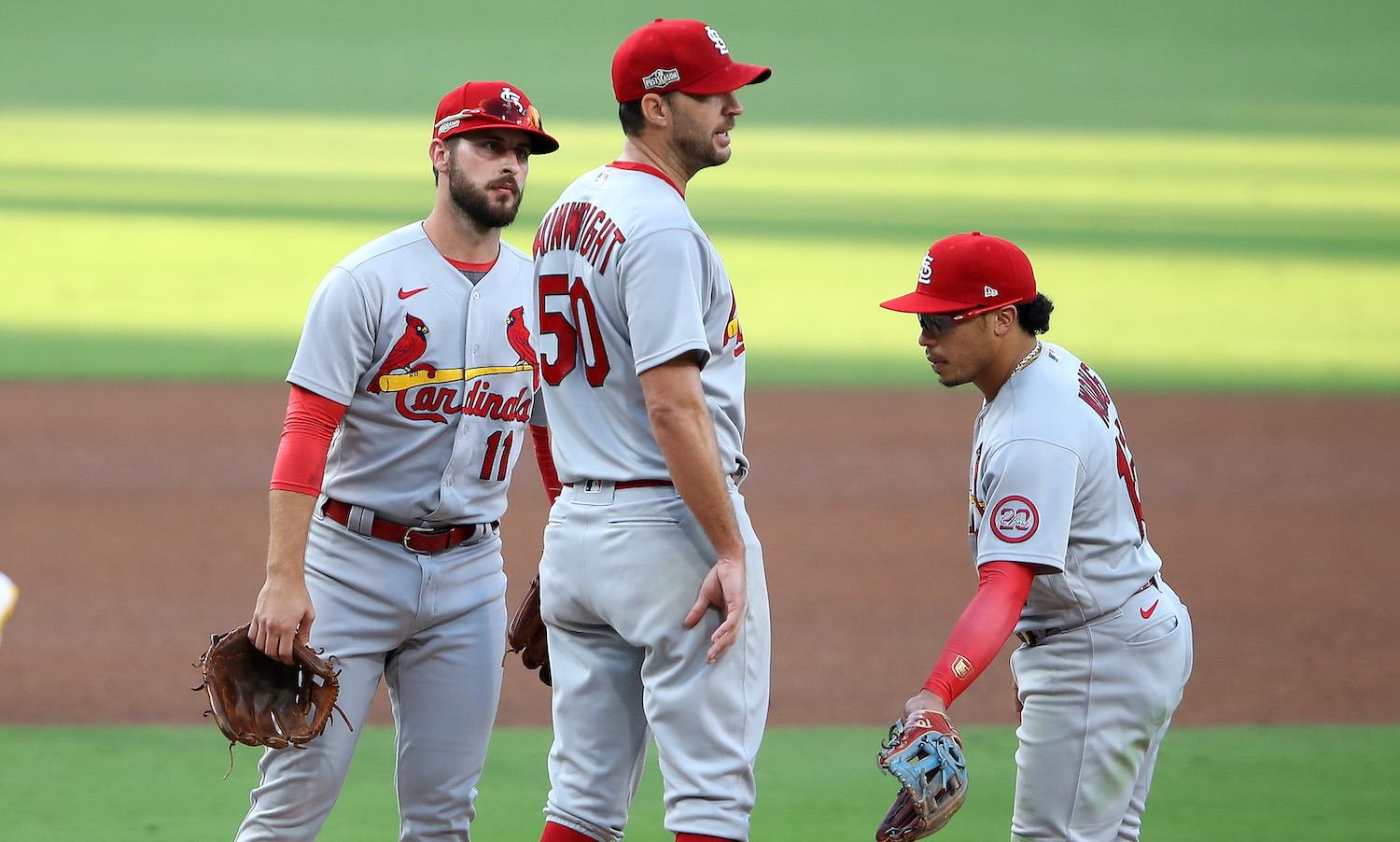 SAN DIEGO, CALIFORNIA - OCTOBER 01: Paul DeJong #11, and Kolten Wong #16 talk with Adam Wainwright #50 of the St. Louis Cardinals as he was being pulled from the game as Wil Myers #4 of the San Diego Padres walks to third base during the fourth inning of Game Two of the National League Wild Card Series at PETCO Park on October 01, 2020 in San Diego, California. (Photo by Sean M. Haffey/Getty Images)