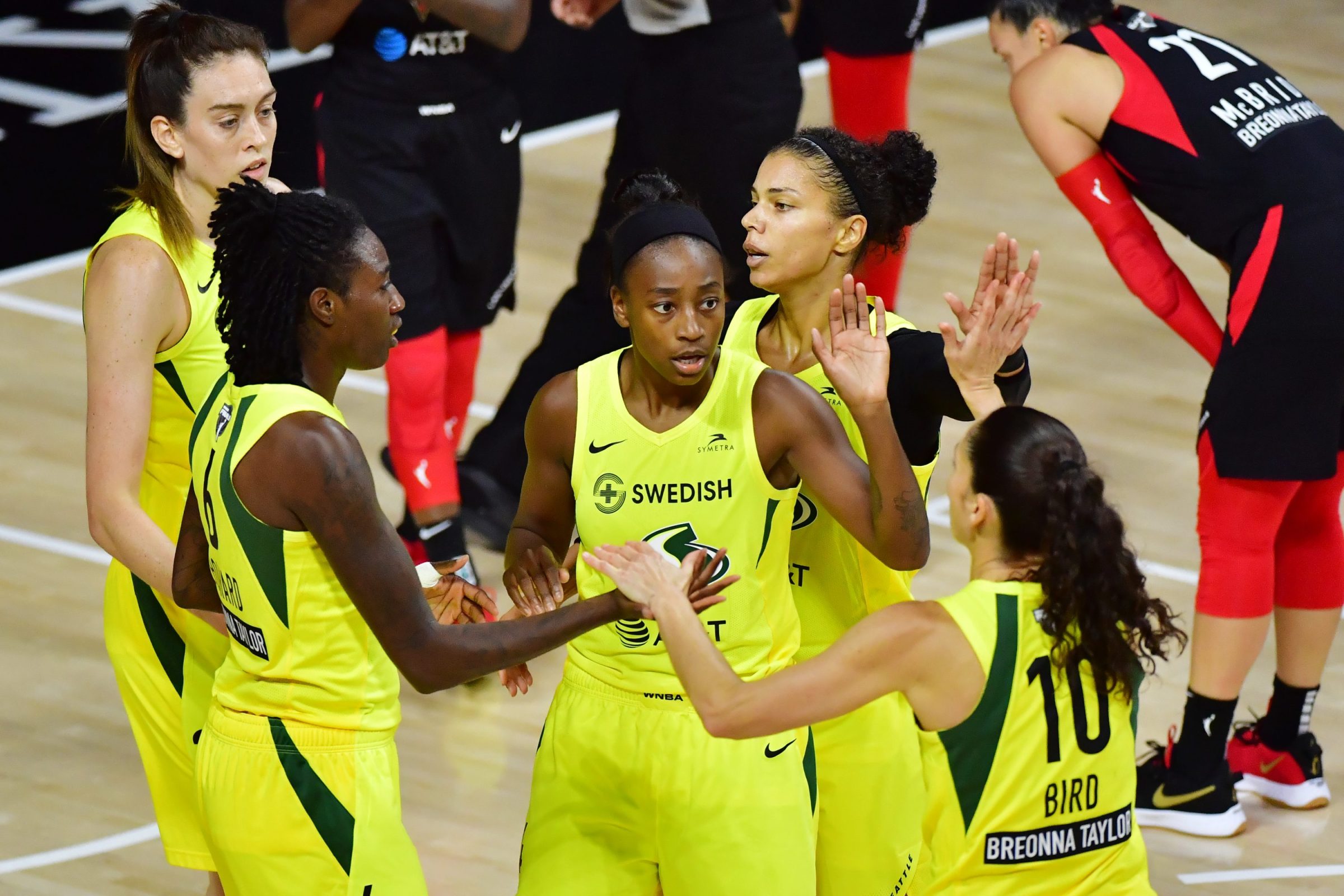 Breanna Stewart #30, Natasha Howard #6, Jewell Loyd #24, Alysha Clark #32, and Sue Bird #10 of the Seattle Storm meet after a foul during the first half of Game Two of the WNBA Finals against the Las Vegas Aces at Feld Entertainment Center on October 04, 2020 in Palmetto, Florida.