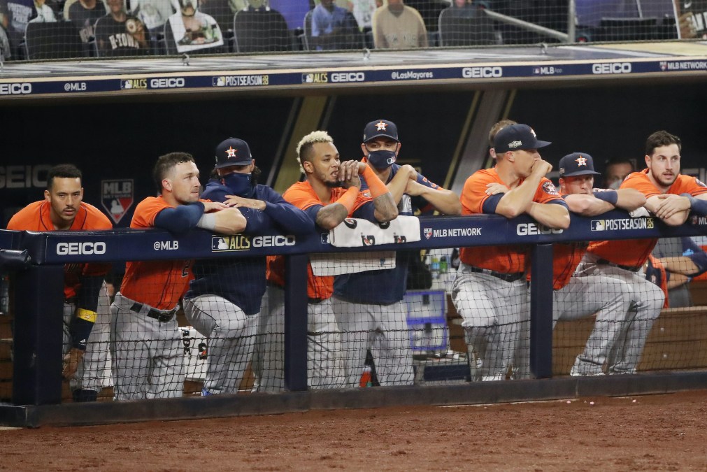 Houston Astros players sit in the dugout during Game 7 of the ALCS.