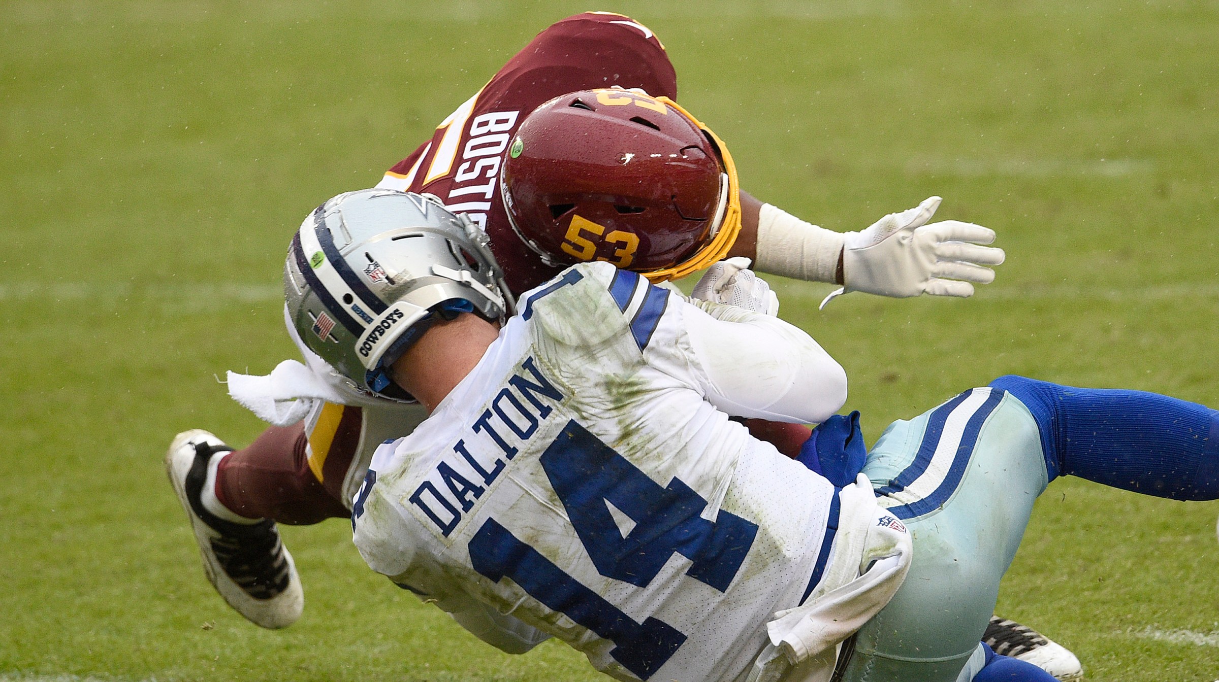 Quarterback Andy Dalton #14 of the Dallas Cowboys is hit and injured by Jon Bostic #53 of the Washington Football Team in the third quarter of the game at FedExField on October 25, 2020
