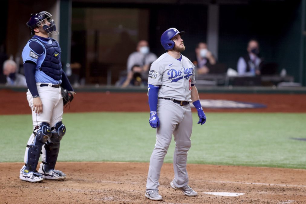 Max Muncy #13 of the Los Angeles Dodgers watches his solo home run leave the park