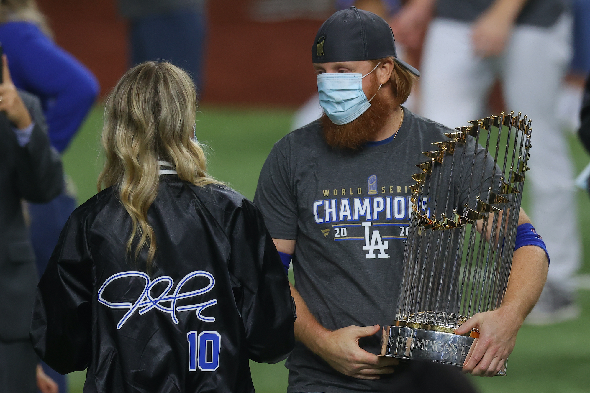 ARLINGTON, TEXAS - OCTOBER 27: Justin Turner #10 of the Los Angeles Dodgers and his wife Kourtney Pogue, hold the Commissioners Trophy after the teams 3-1 victory against the Tampa Bay Rays in Game Six to win the 2020 MLB World Series at Globe Life Field on October 27, 2020 in Arlington, Texas. (Photo by Ronald Martinez/Getty Images)