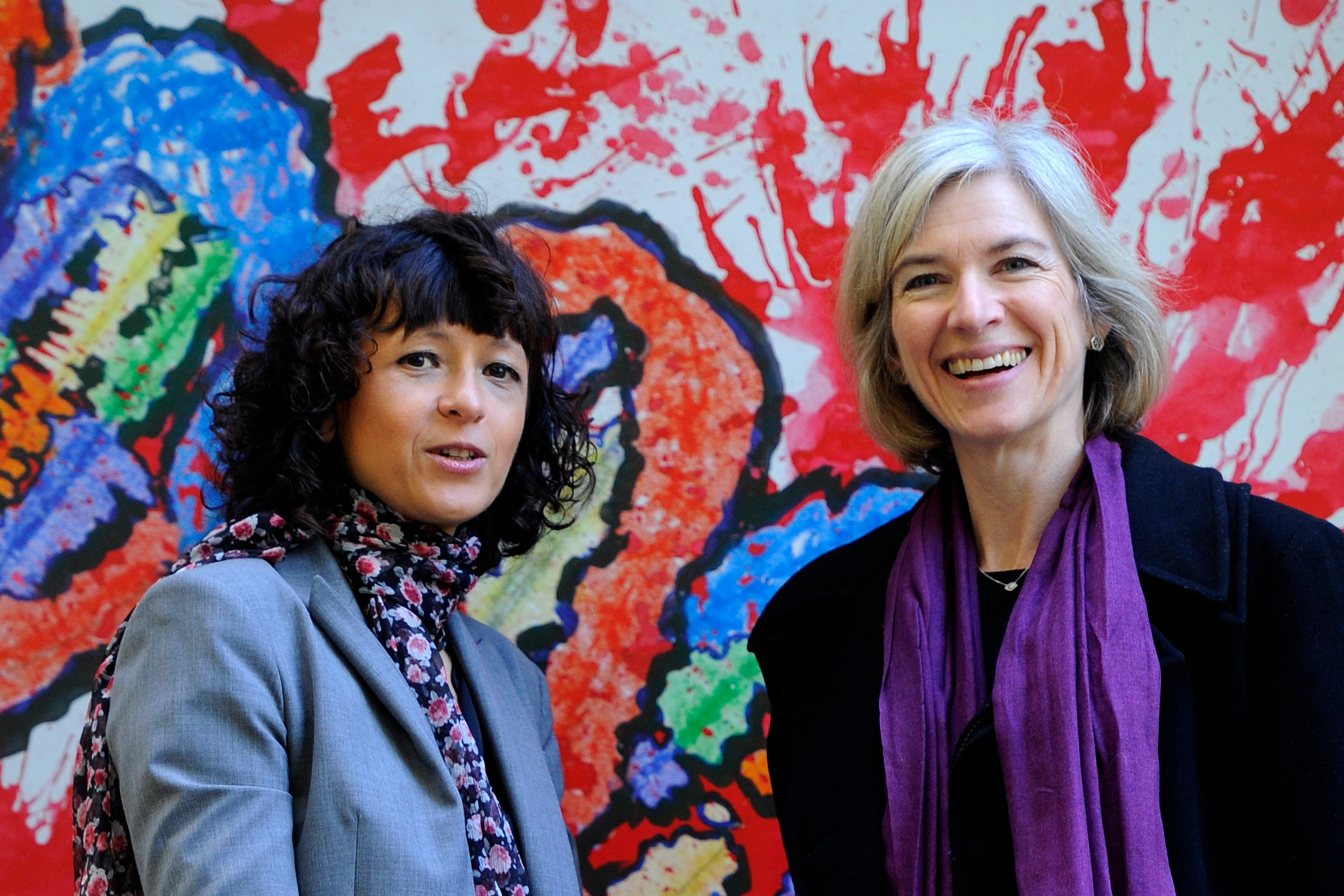 French researcher in Microbiology, Genetics and Biochemistry Emmanuelle Charpentier (L) and US professor of Chemistry and of Molecular and Cell Biology, Jennifer Doudna pose beside a painting made by children of the genome at the San Francisco park in Oviedo, on October 21, 2015.