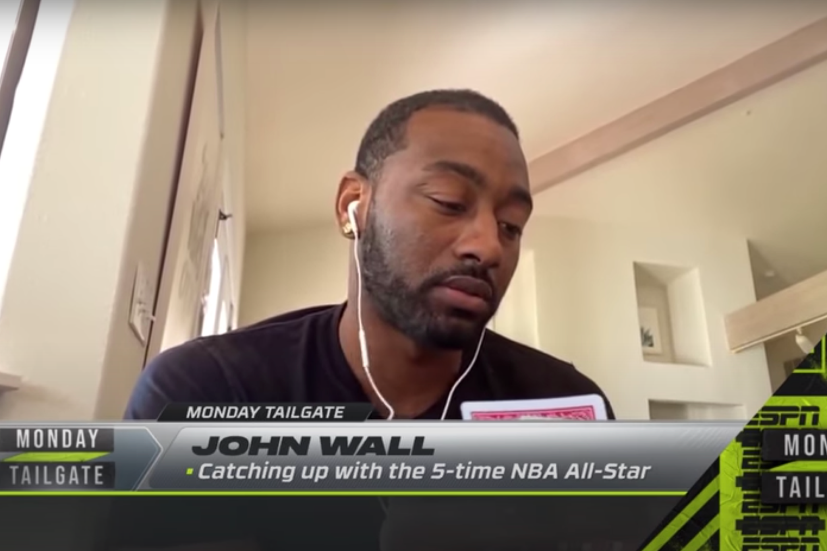 John Wall examines his cards during a live TV segment