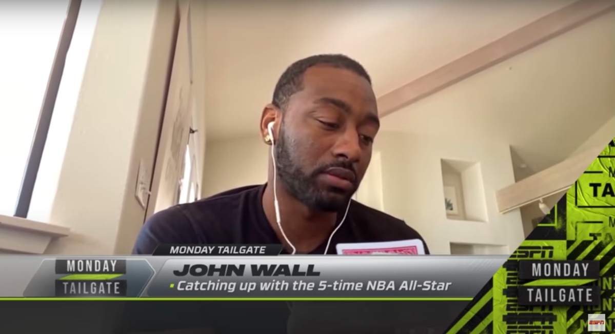 John Wall examines his cards during a live TV segment