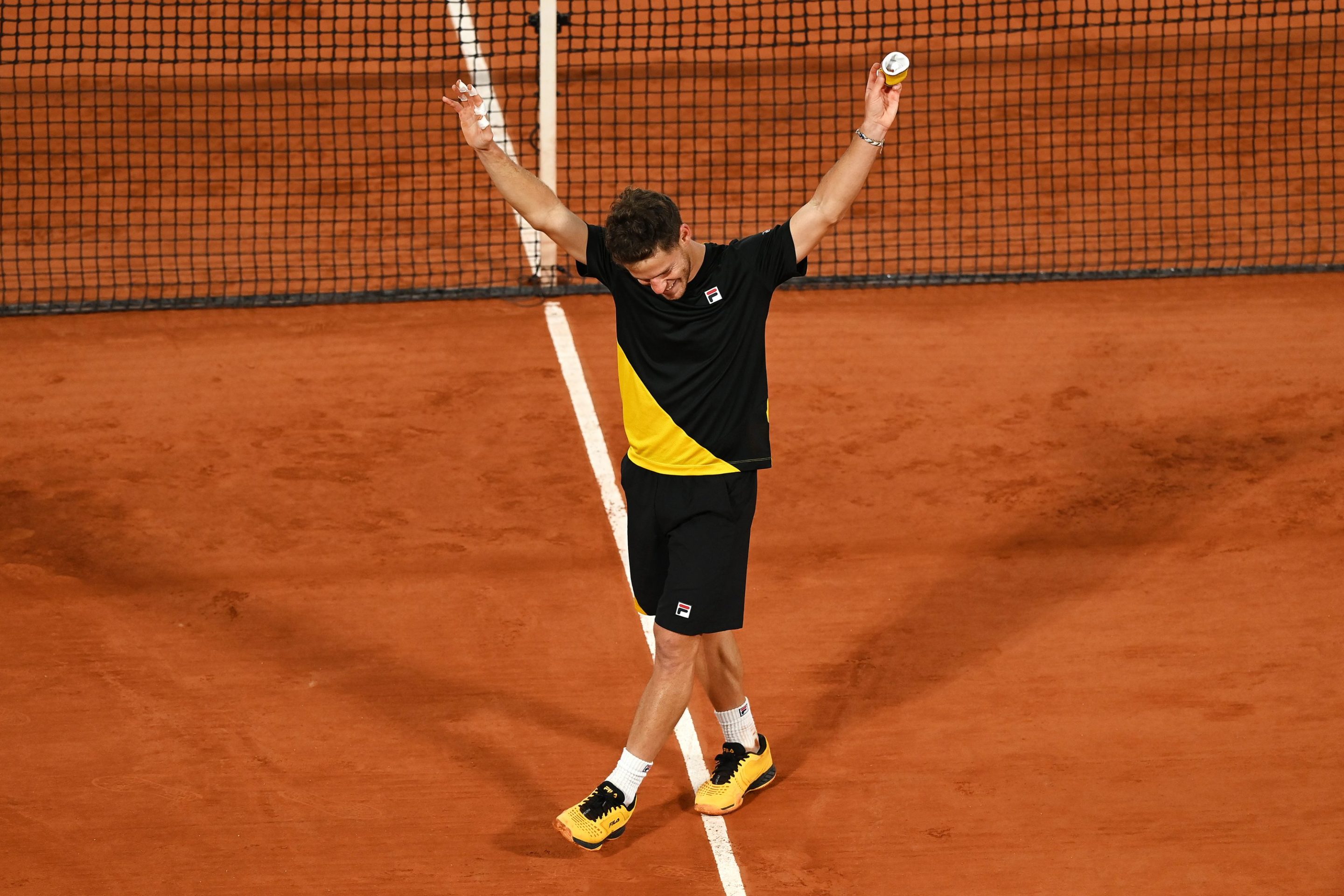 Diego Schwartzman celebrates on court after his French Open quarterfinal win.