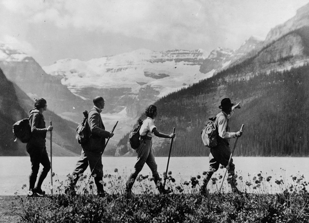 Hikers stroll past lake