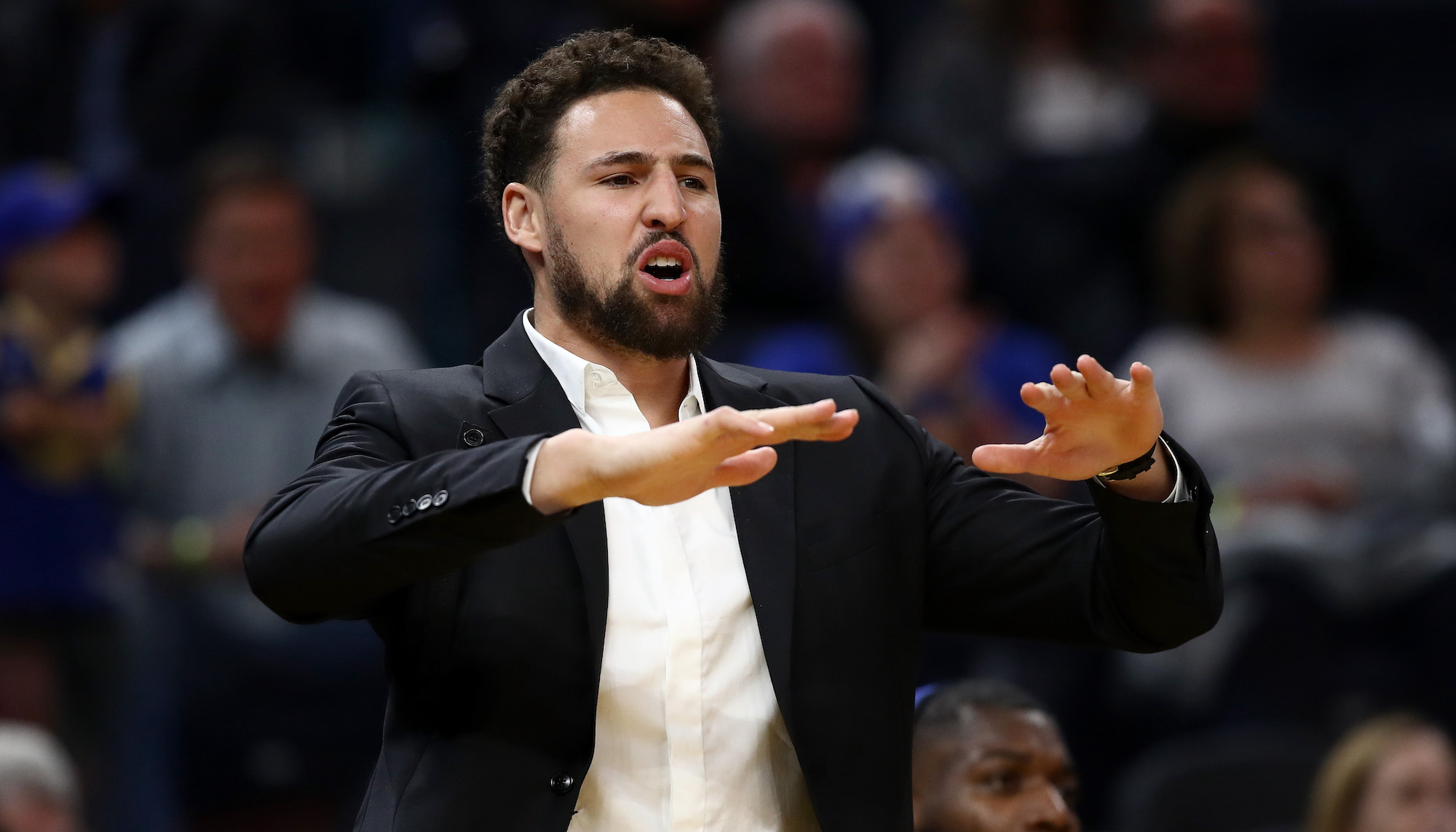 SAN FRANCISCO, CALIFORNIA - NOVEMBER 25: Injured Klay Thompson #11 of the Golden State Warriors reacts on the bench after the Warriors made a basket against the Oklahoma City Thunder at Chase Center on November 25, 2019 in San Francisco, California. NOTE TO USER: User expressly acknowledges and agrees that, by downloading and or using this photograph, User is consenting to the terms and conditions of the Getty Images License Agreement. (Photo by Ezra Shaw/Getty Images)