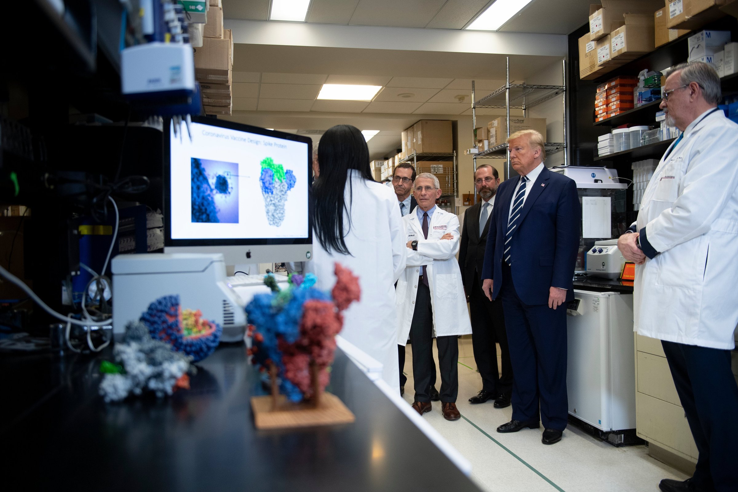 National Institute of Allergy and Infectious Diseases Director Tony Fauci (C) looks on next to US President Donald Trump during a tour of the National Institutes of Health's Vaccine Research Center March 3, 2020, in Bethesda, Maryland