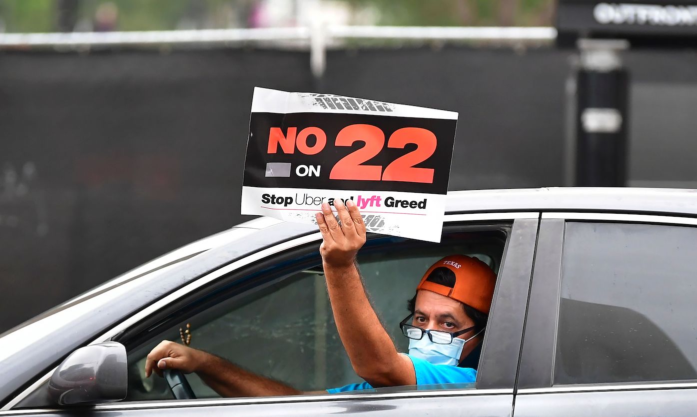 App-based drivers from Uber and Lyft protest in a caravan in front of City Hall in Los Angeles on October 22, 2020 where elected leaders hold a conference urging voters to reject on the November 3 election, Proposition 22, that would classify app-based drivers as independent contractors and not employees or agents. (Photo by Frederic J. BROWN / AFP) (Photo by FREDERIC J. BROWN/AFP via Getty Images)