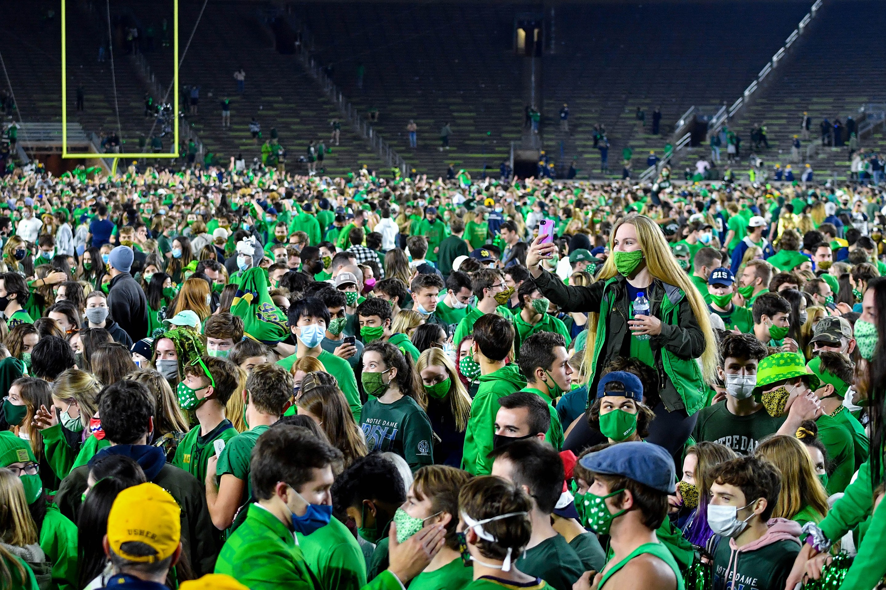 Fans storm the field after the Notre Dame Fighting Irish defeated the Clemson Tigers 47-40 in double overtime at Notre Dame Stadium on November 7, 2020