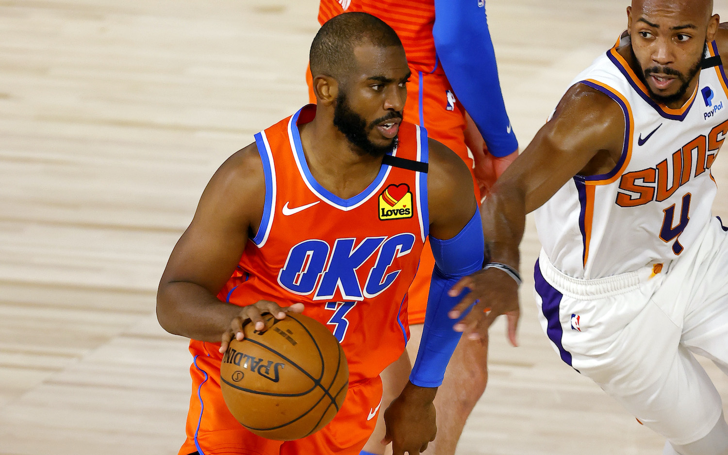 LAKE BUENA VISTA, FLORIDA - AUGUST 10: Chris Paul #3 of the Oklahoma City Thunder is pressured by Jevon Carter #4 of the Phoenix Suns during the second quarter at The Field House at ESPN Wide World Of Sports Complex on August 10, 2020 in Lake Buena Vista, Florida. NOTE TO USER: User expressly acknowledges and agrees that, by downloading and or using this photograph, User is consenting to the terms and conditions of the Getty Images License Agreement. (Photo by Mike Ehrmann/Getty Images)