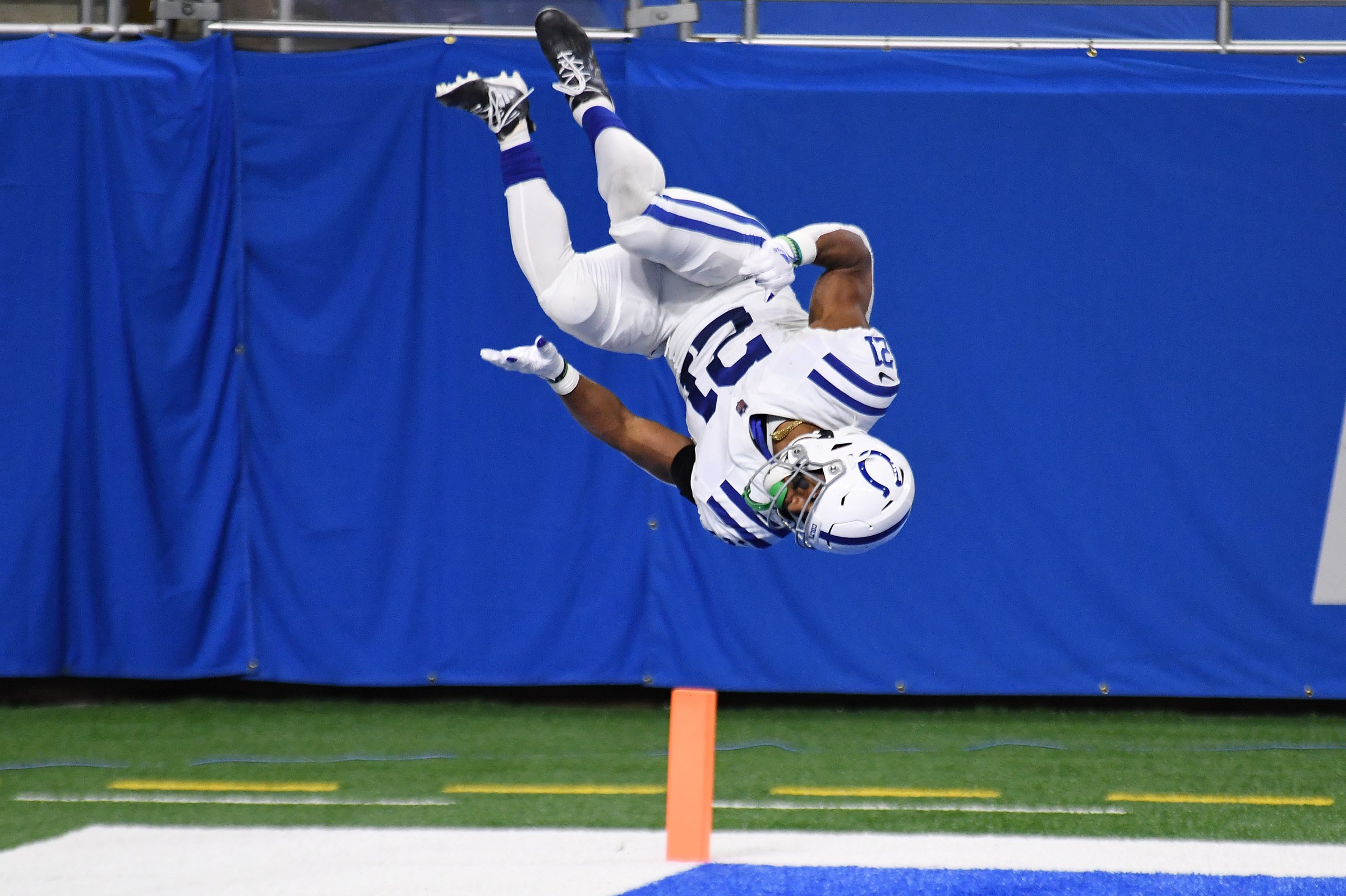 Colts player Nyheim Hines is caught suspended upside down during one of his touchdown celebration flips