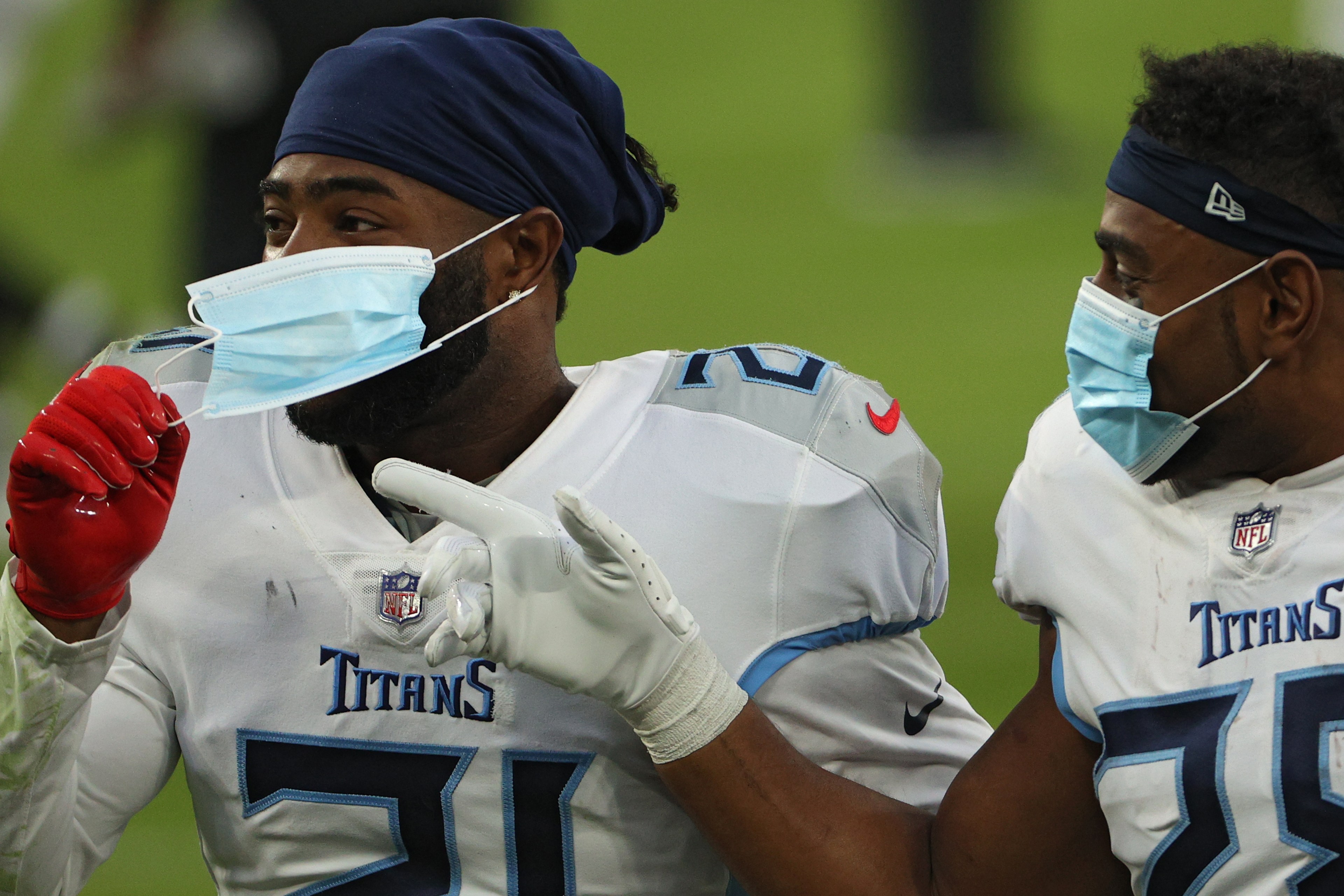 Two Titans players wear masks