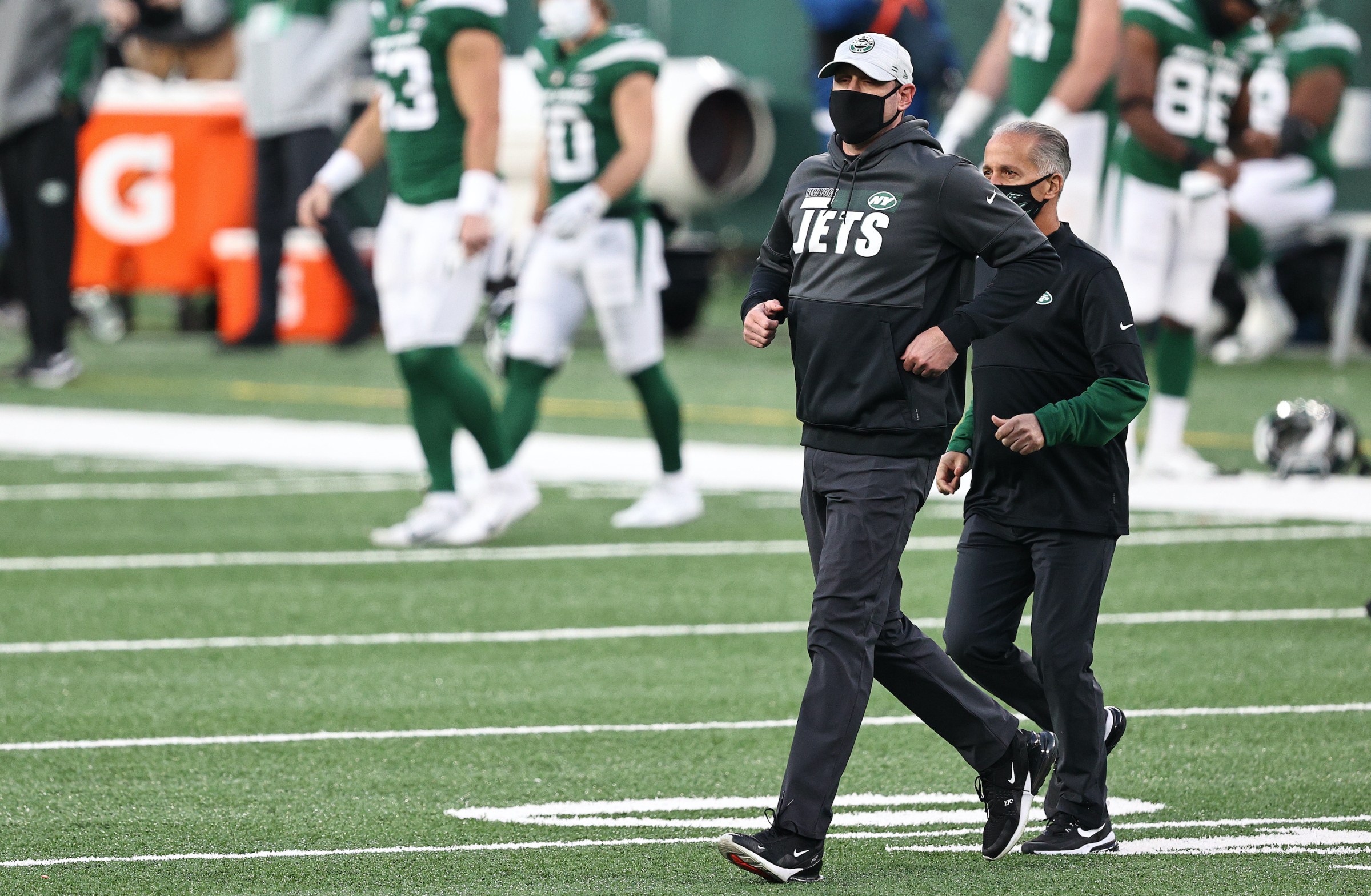 New York Jets coach Adam Gase walks on the field.