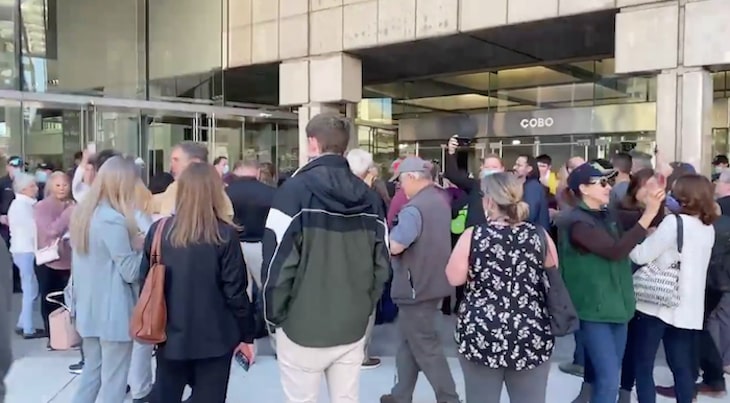 A crowd of dorks chants "stop the vote" in front of an election station in Detroit.